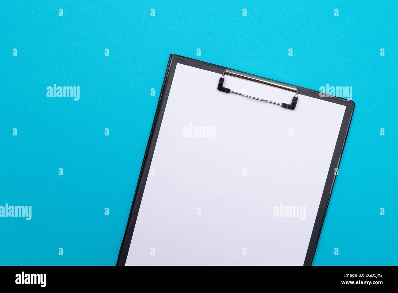 Black Clipboard with Blank White Sheet of Paper Lying on Blue Table ...