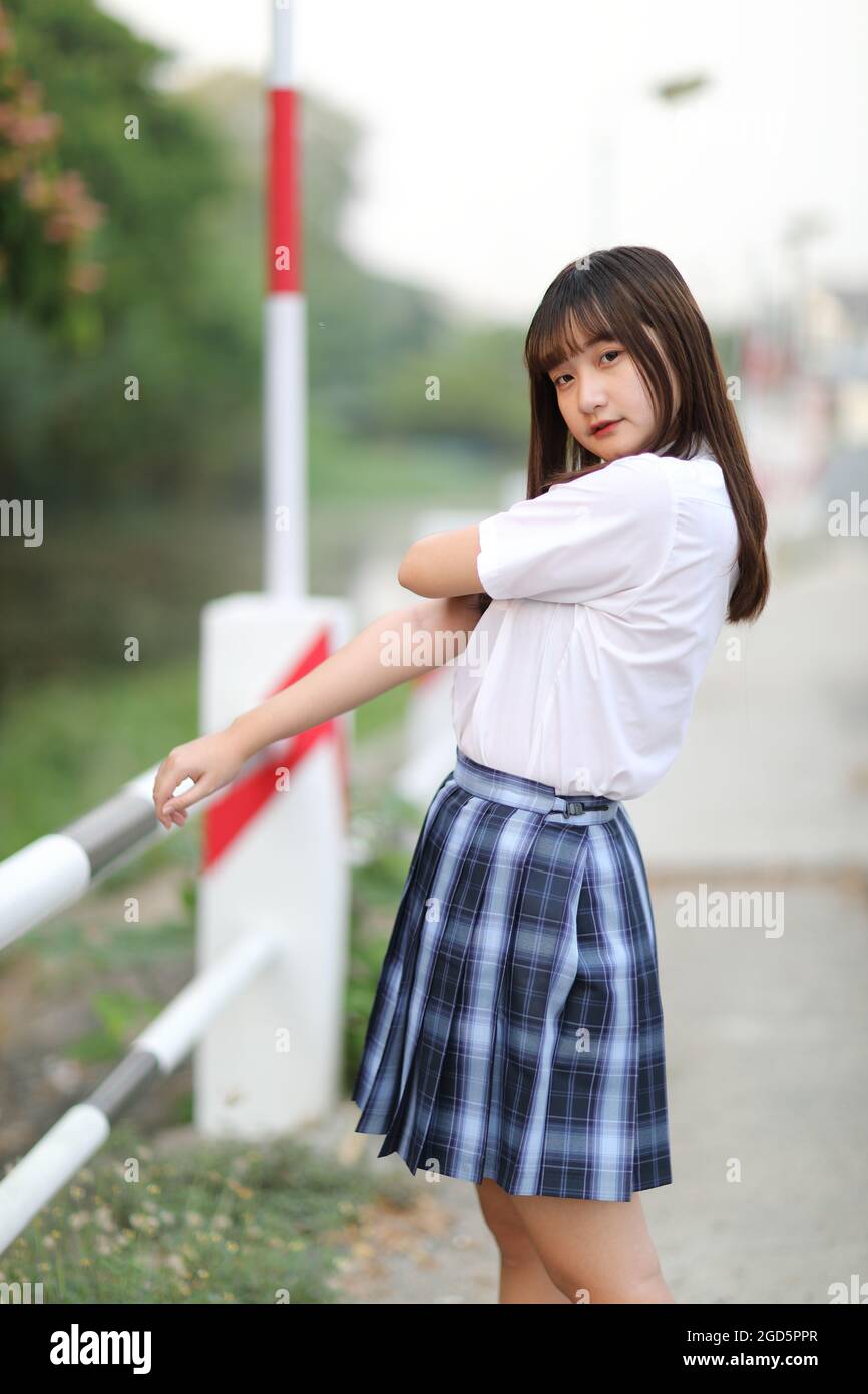beautiful asian japanese school girl uniform looking at park outdoor ...