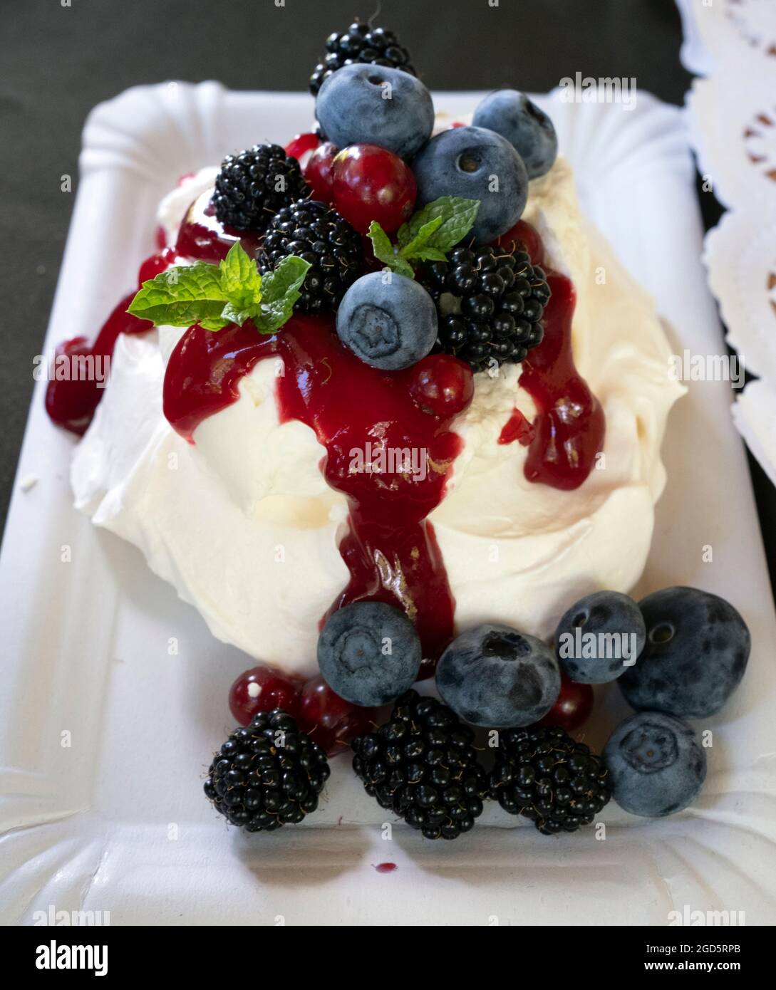 The Home Cafe “Tie jau tikai pumpuriņi” sweet offering a set of  whipped cream, blueberries and caneberries in Sigulda city, Latvia Stock Photo
