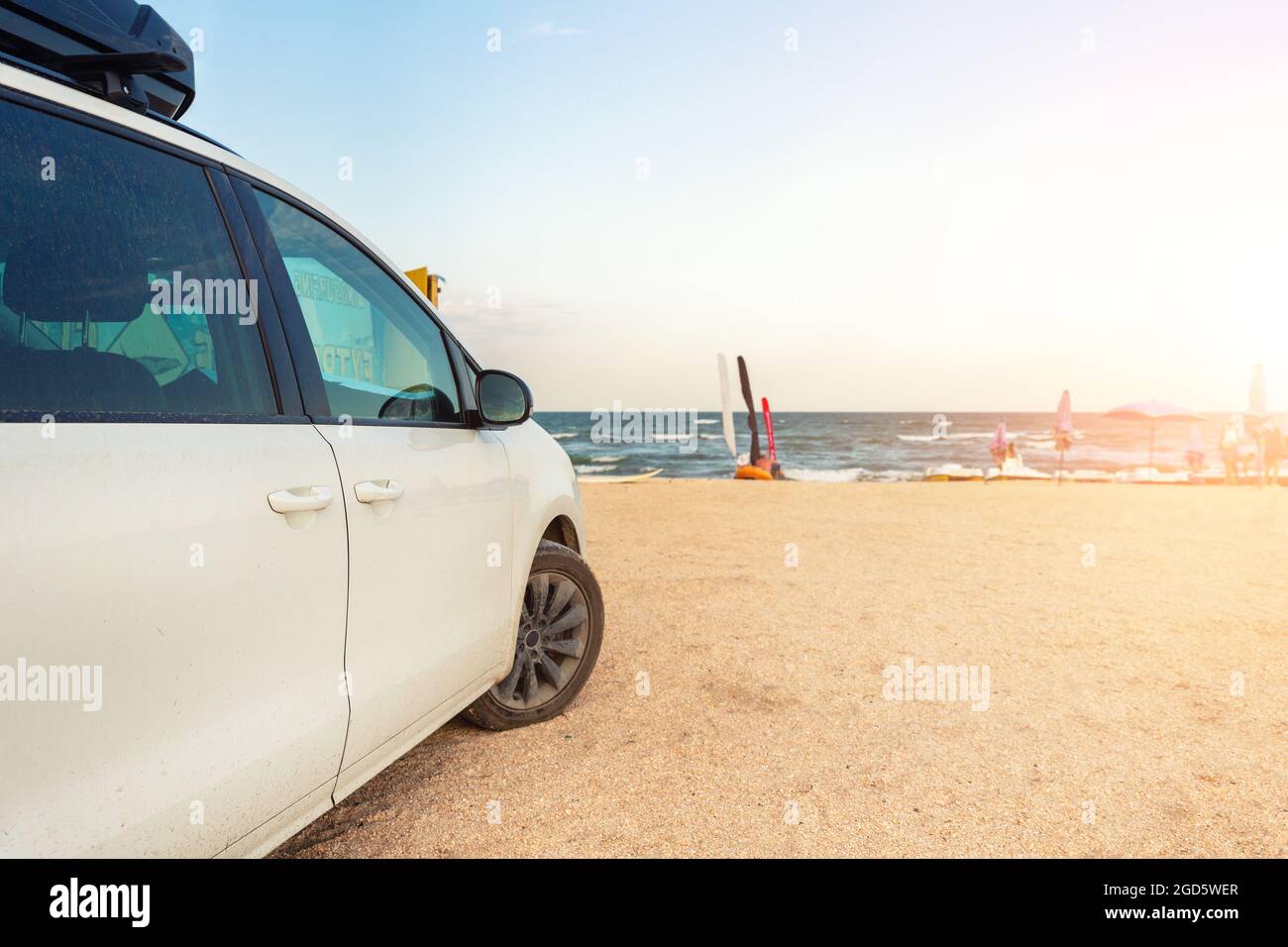 Side view of big family white suv van car with big rooftop cargo rack ...