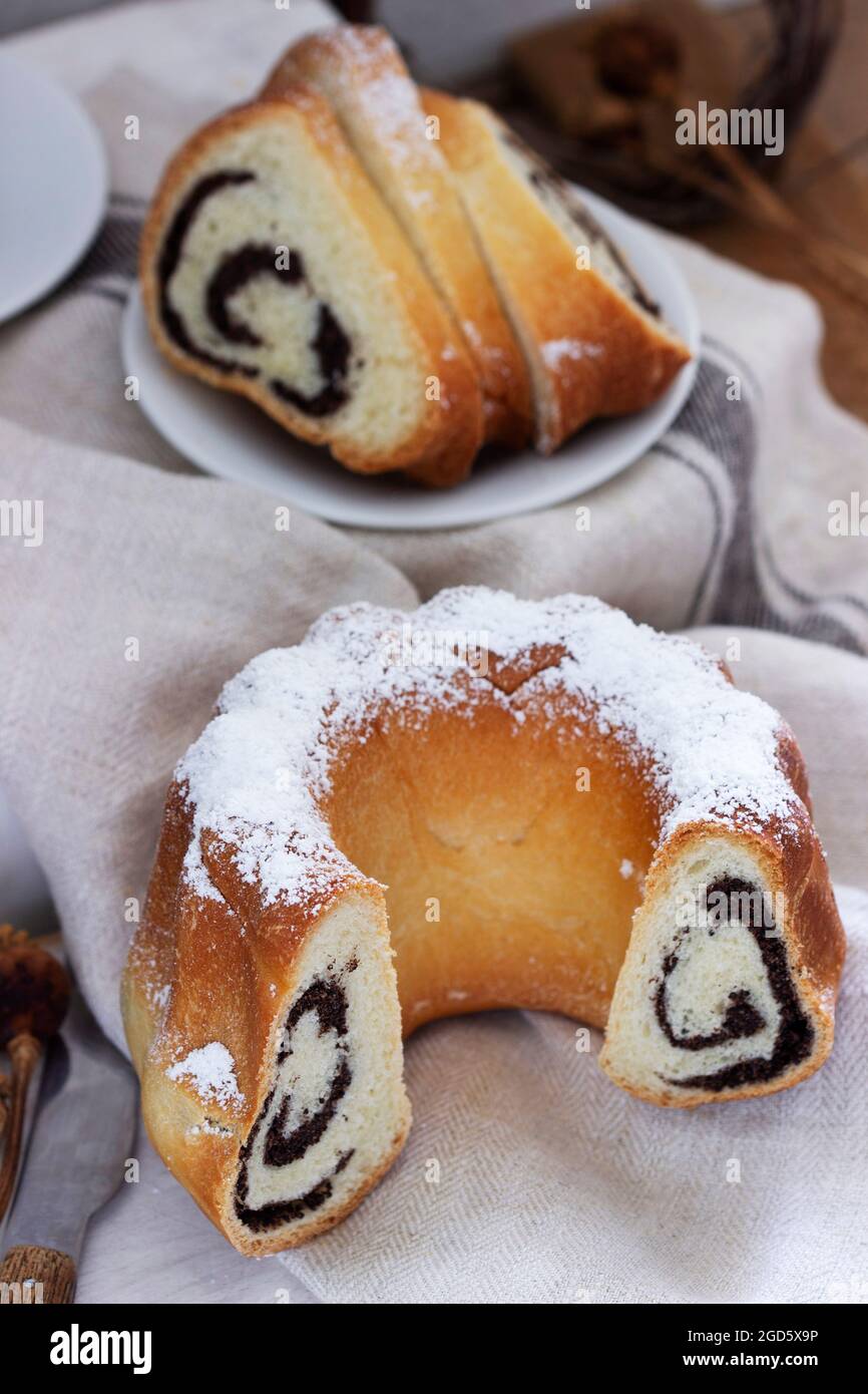 Poppy seed cake made from yeast dough and coffee on a light background