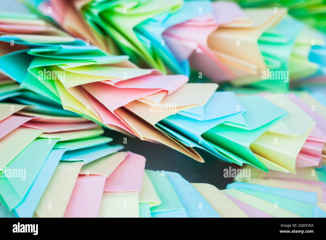 Abstract parametric structure made of colorful paper sheets. Origami background, close up photo with selective focus Stock Photo