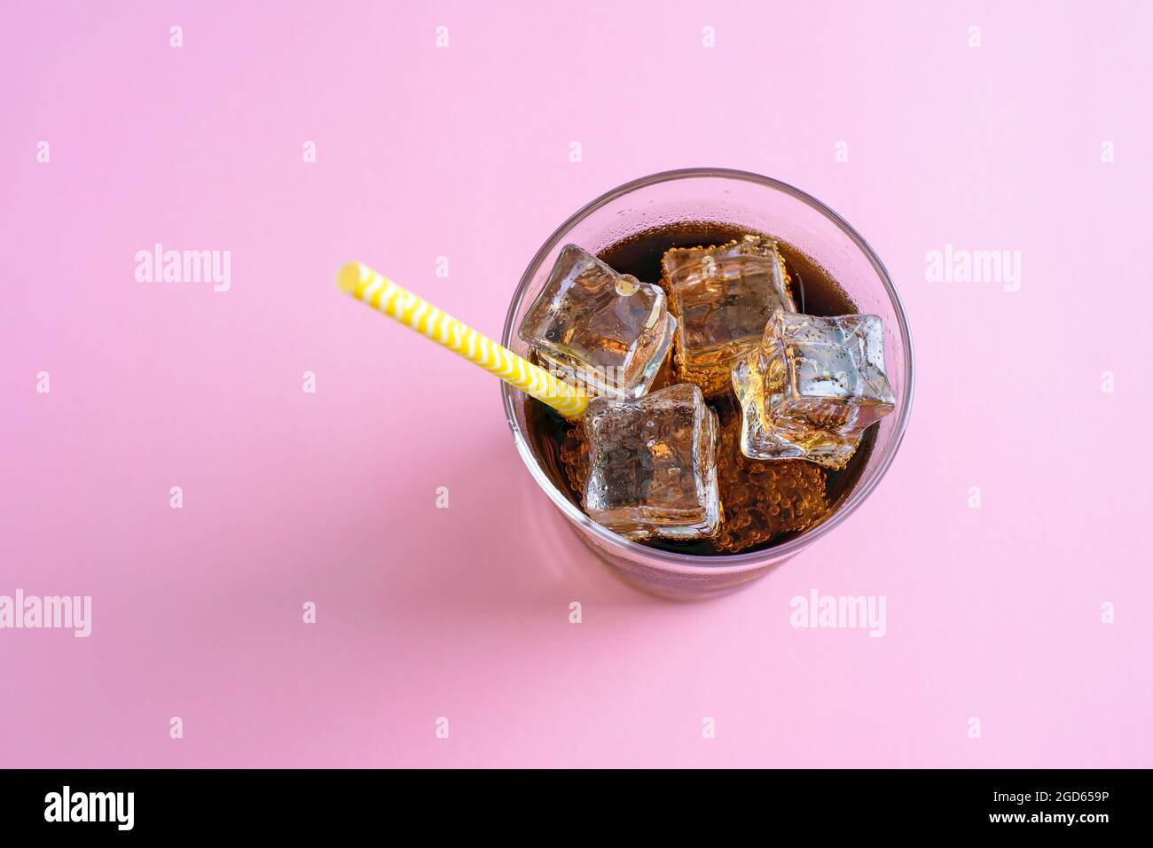 Top view of a glass of cola with ice cubes on pink background Stock ...