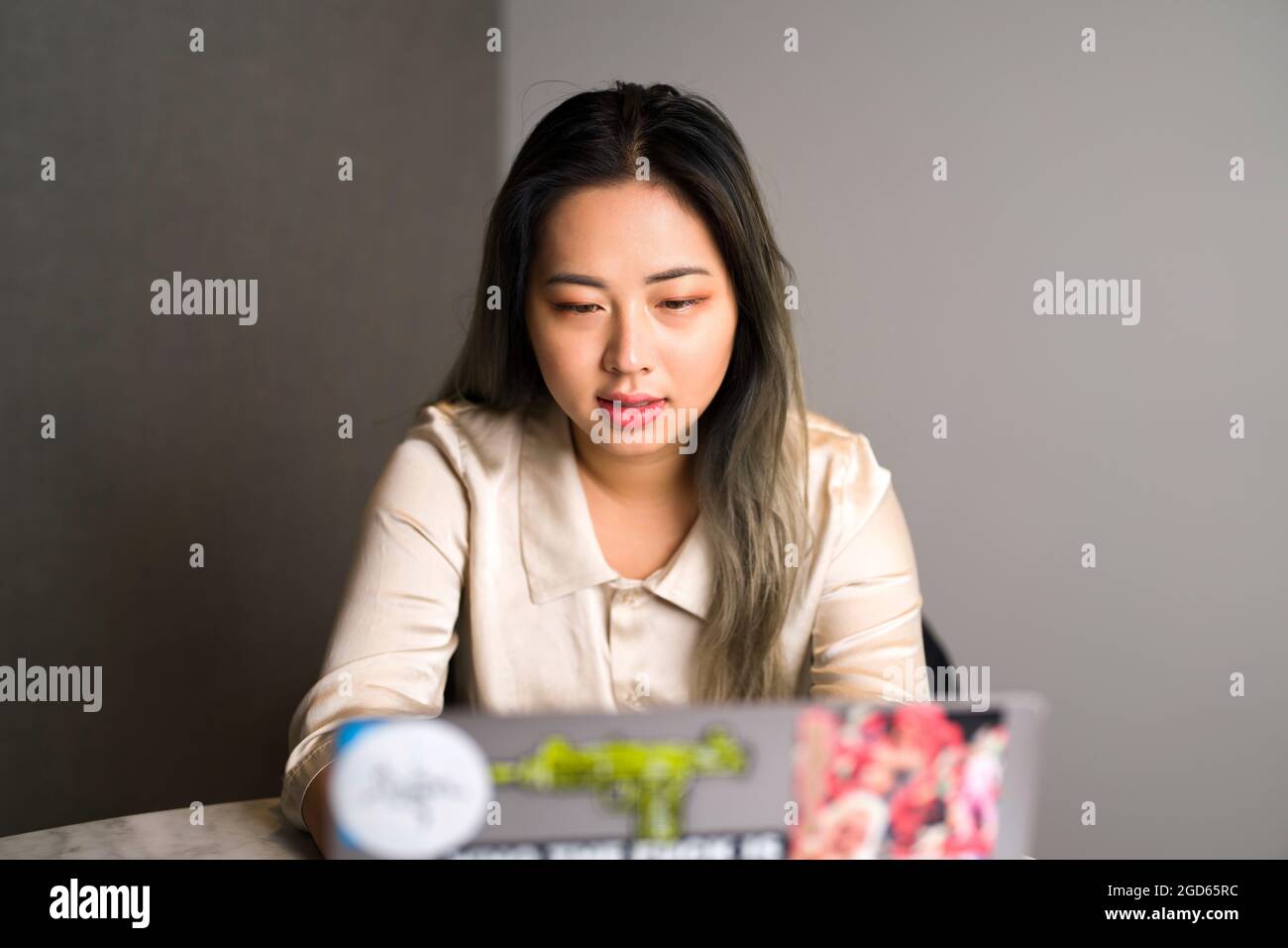 Young Edgy Asian Data Scientist on a Video Conference Stock Photo