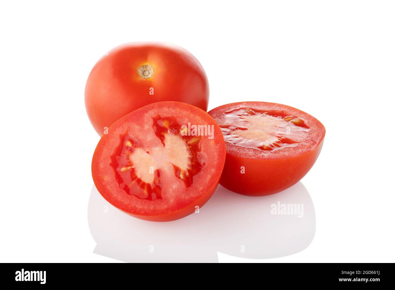 Sliced tomatoes. Two half one whole tomato on white background Stock Photo