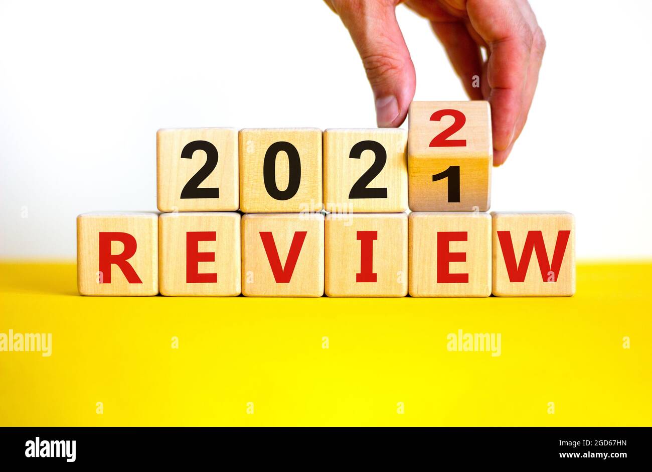 2022 review new year symbol. Businessman turns a wooden cube and ...