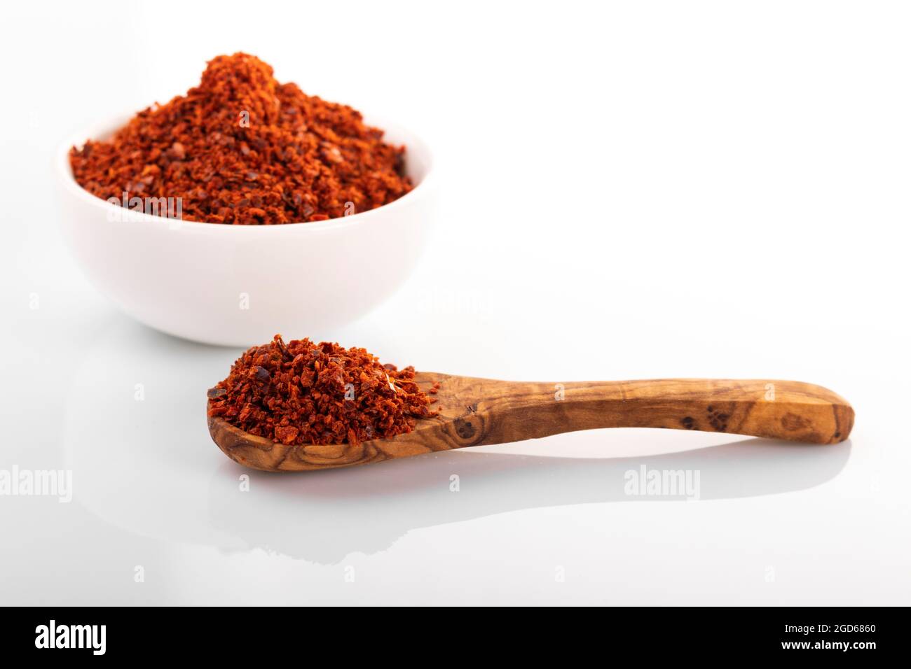 Korean hot pepper flakes. Pepper flakes in white bowl, on white