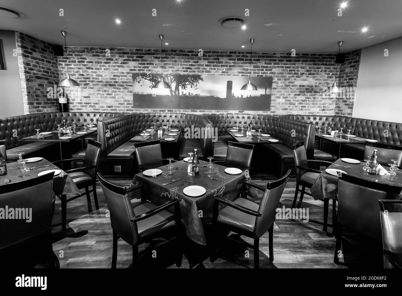 JOHANNESBURG, SOUTH AFRICA - Jan 05, 2021: A grayscale of an interior of booth style restaurant diner in Johannesburg, South Africa Stock Photo