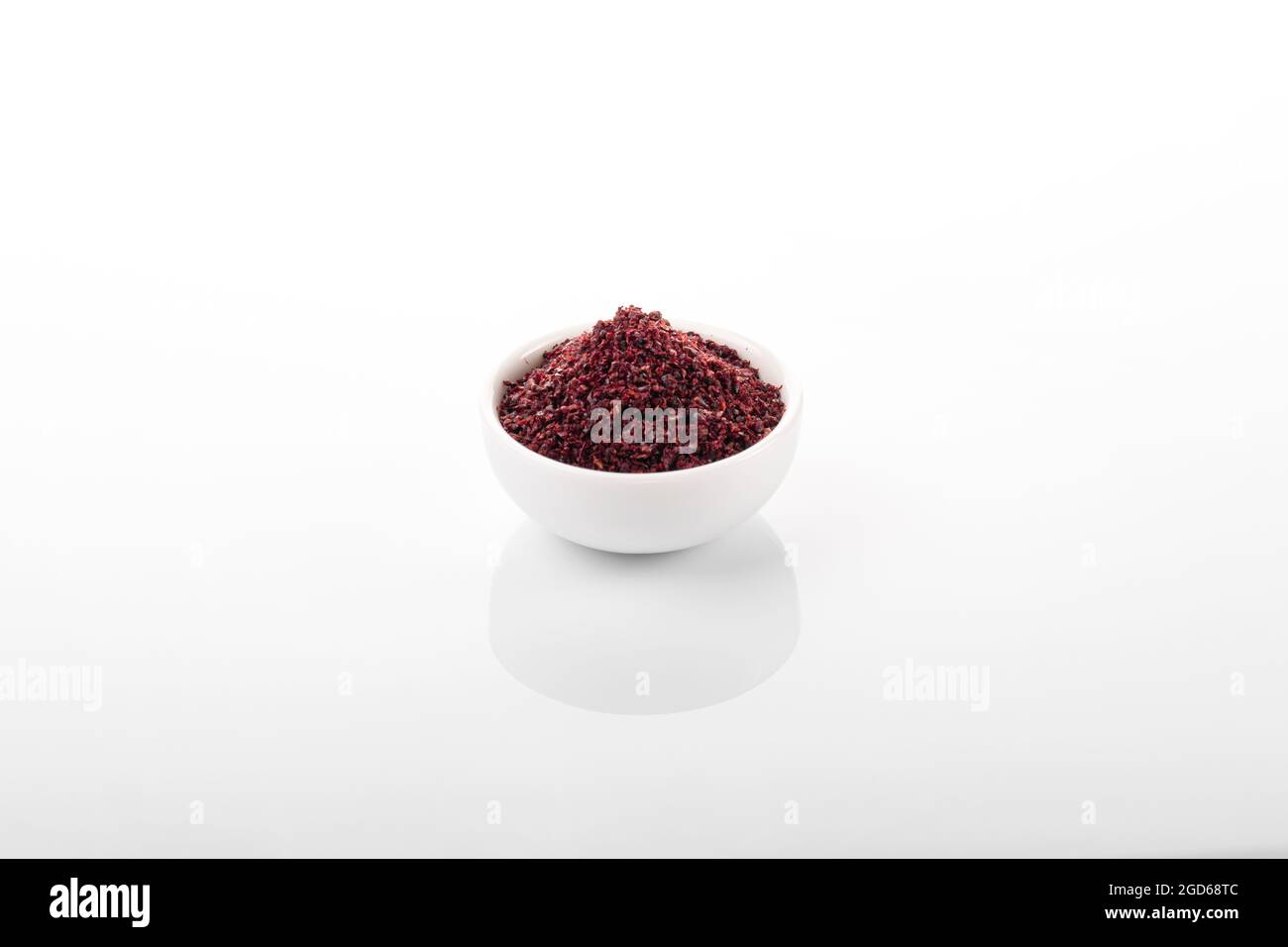 Sumac. Sumac spice in white bowl, on white background. Sumac, sumac
