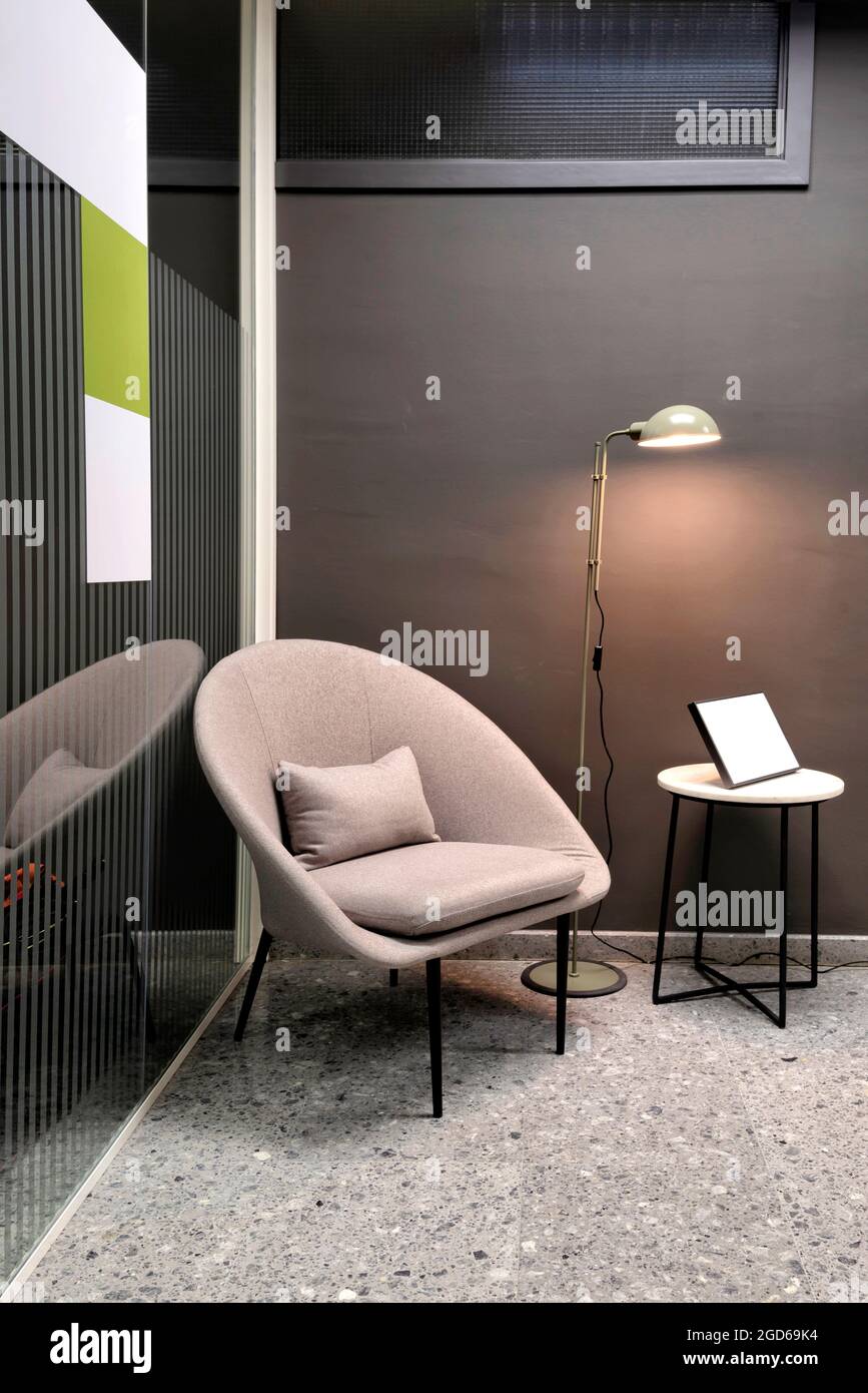 Vertical view of comfortable armchair in office with modern interior design. Stock Photo