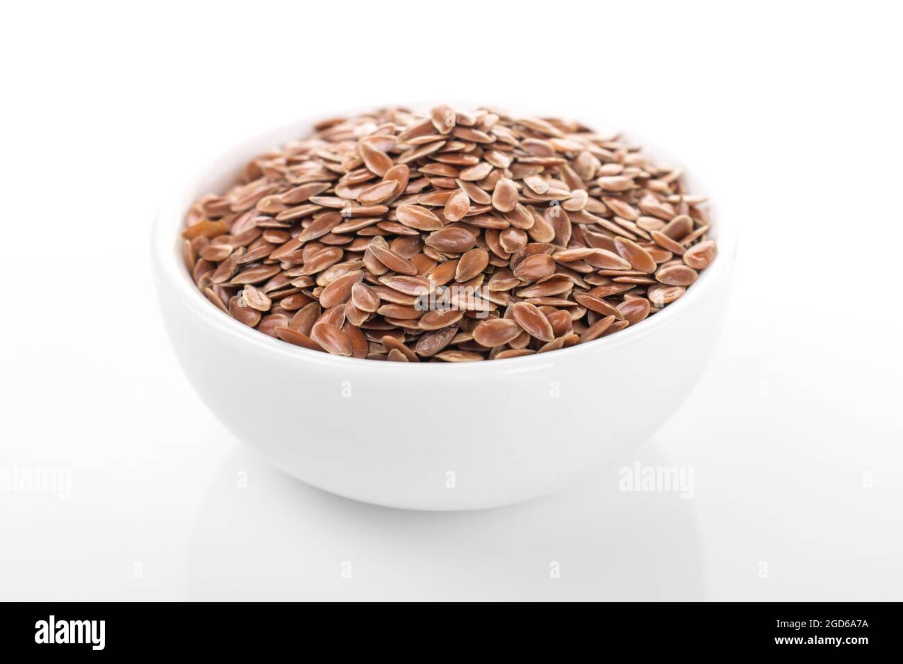 flax seed. flax seed in white bowl on white background. flax, seed. macro photo flax seed. Stock Photo