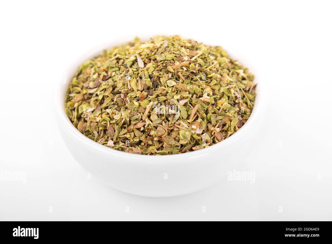dry oregano. dry oregano spice in wooden bowl on white background