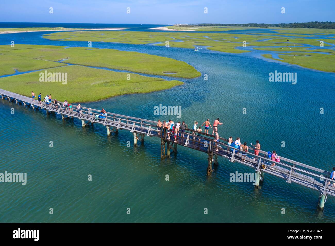 Children jumping of the bridge on Sandwich Boardwalk, Sandwich, Massachusetts, Cape Cod Stock Photo