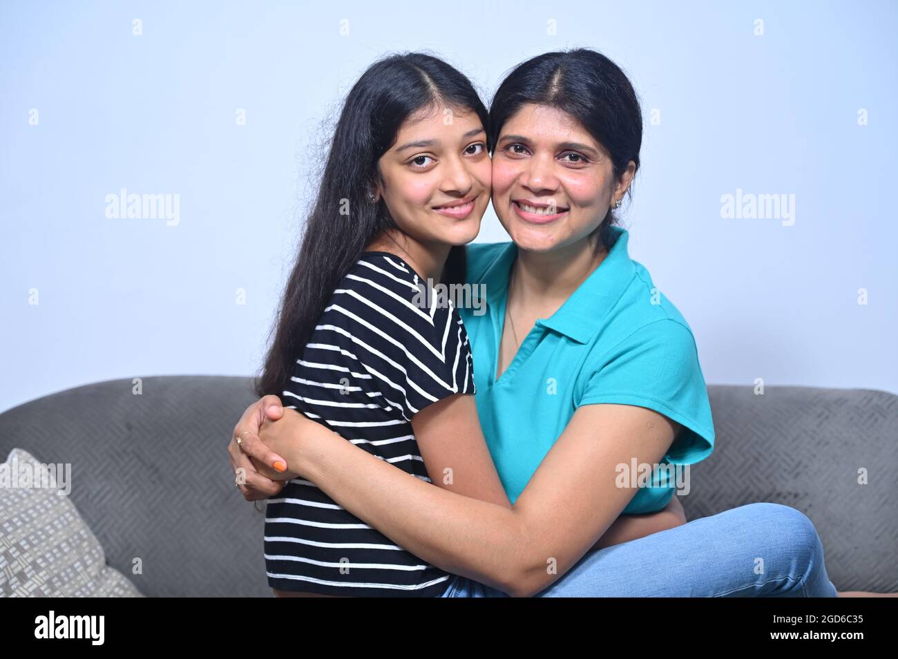 daughter happily spending time with mother at home. Stock Photo