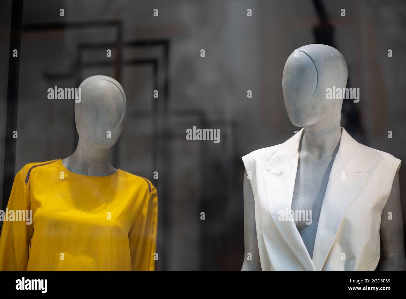 Two mannequins in a shop window. Modern mannequin for displaying