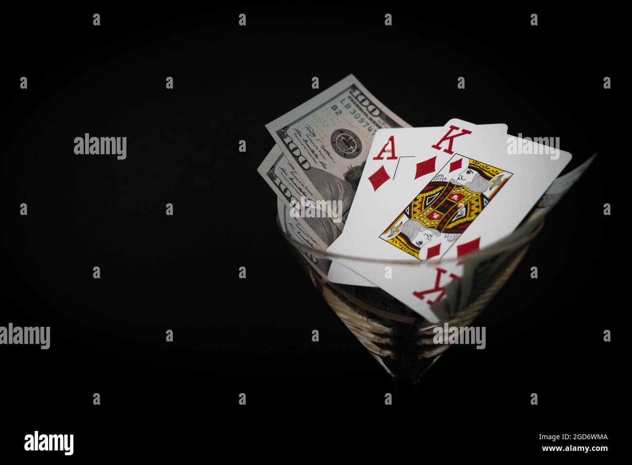 Poker Cards King Ace Of Diamond High Card With 300 Dollar Bills On Black Background Cocktail Glass Stock Photo Alamy