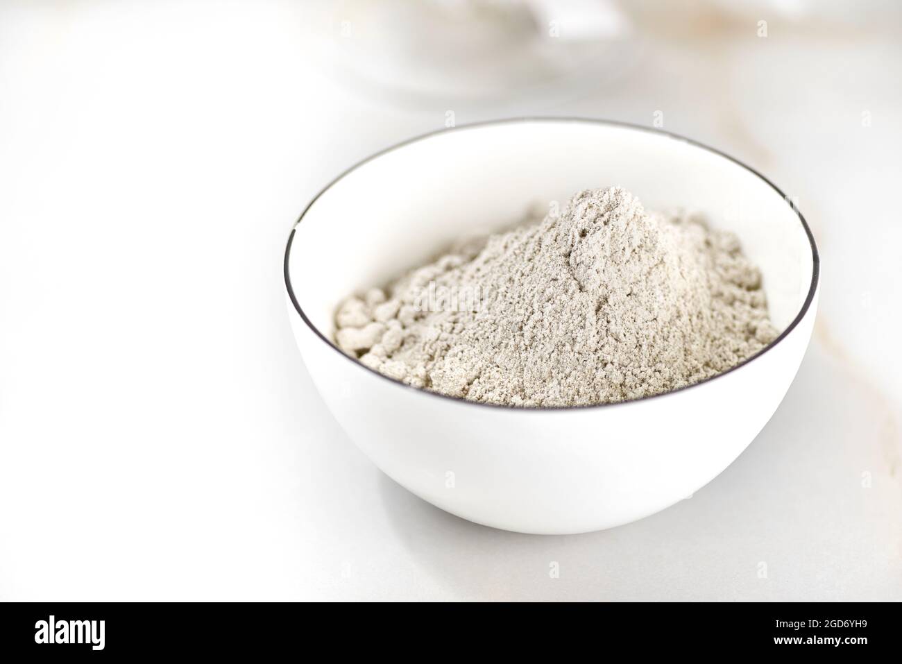 bowl of flour on a light table. selective focus Stock Photo