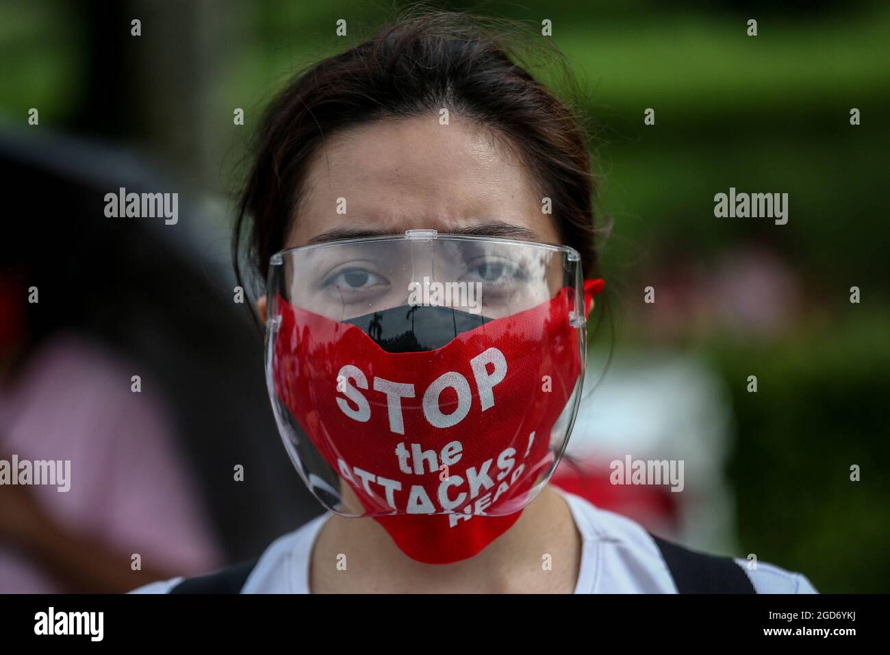 A protester wears a protective mask with a sign ahead of President Rodrigo Duterte's last state of the nation address in Quezon City, Metro Manila. Thousands of left-wing protesters gathered and marched toward the Philippine Congress where Duterte delivered his final state of the nation speech, winding down his six-year term amidst criticisms such as alleged human rights violations, mishandling of the coronavirus pandemic and inaction to confront China’s aggressive behavior in the disputed South China Sea. Philippines. Stock Photo