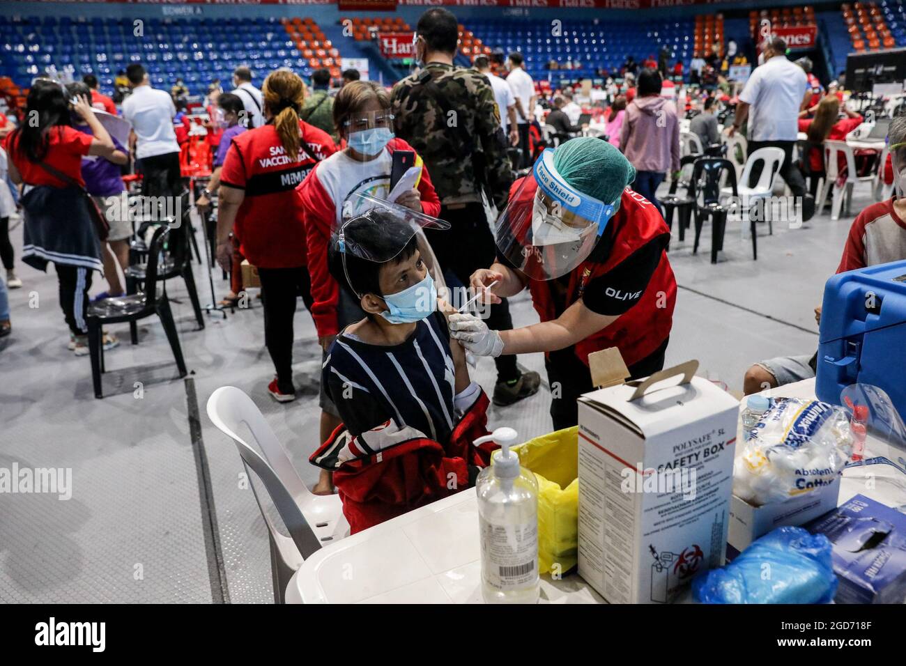 Medical workers inoculate persons with disabilities with the Johnson & Johnson COVID-19 vaccine at the Filoil Flying-V Arena in San Juan City. Philippine officials said a local transmission of the highly contagious delta variant of the COVID-19 virus has been detected in the country and announced tighter quarantine restrictions in the capital and a ban on the entry of travelers from hard-hit Malaysia and Thailand. Metro Manila, Philippines. Stock Photo