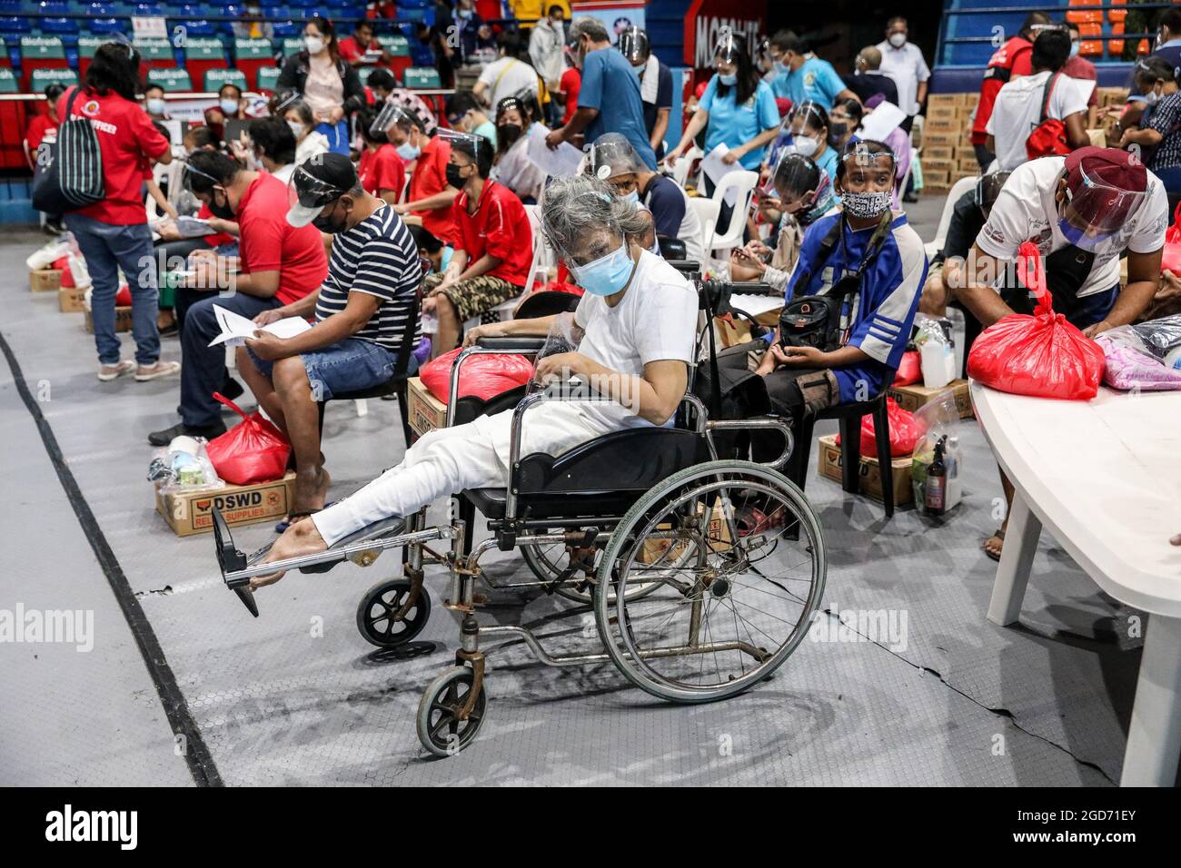 Persons with disabilities receiving a dose of the Johnson & Johnson COVID-19 vaccine at the Filoil Flying-V Arena in San Juan City. Philippine officials said a local transmission of the highly contagious delta variant of the COVID-19 virus has been detected in the country and announced tighter quarantine restrictions in the capital and a ban on the entry of travelers from hard-hit Malaysia and Thailand. Metro Manila, Philippines. Stock Photo