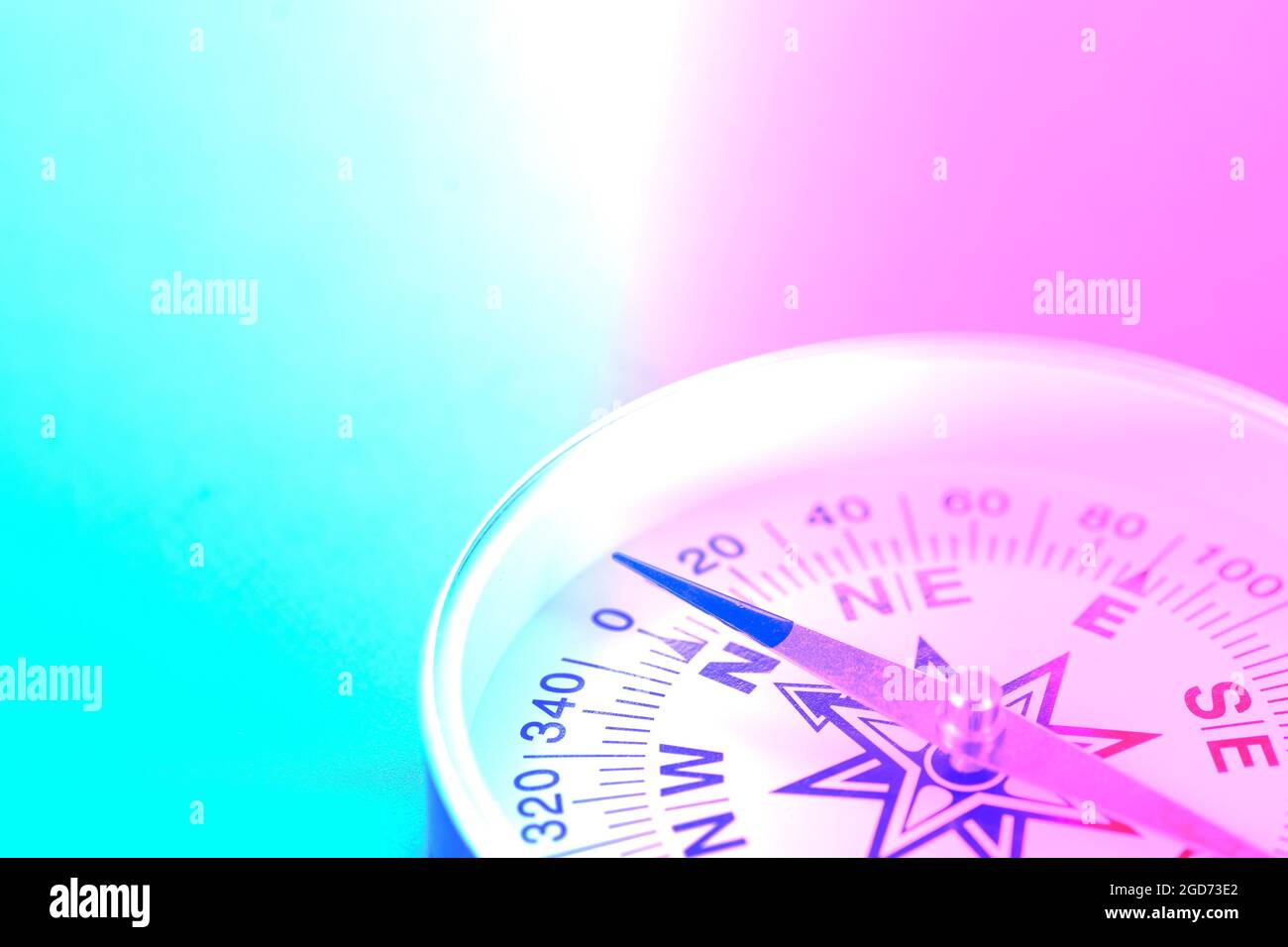 Travel compass close up in neon light. Stock Photo