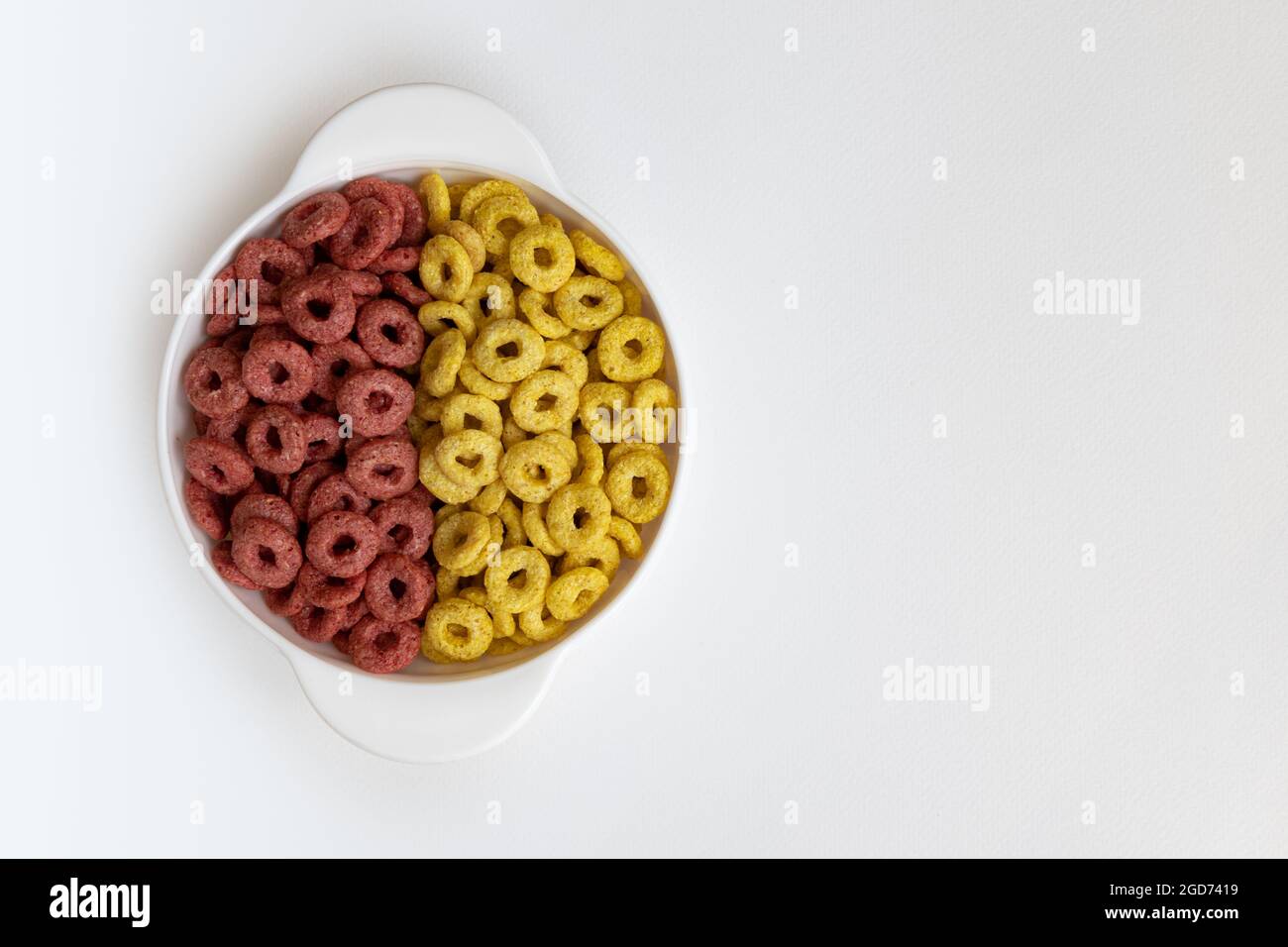 bowl of whole whole grain cereal rings isolated on white background, healthy breakfast concept, plate of delicious rings Stock Photo