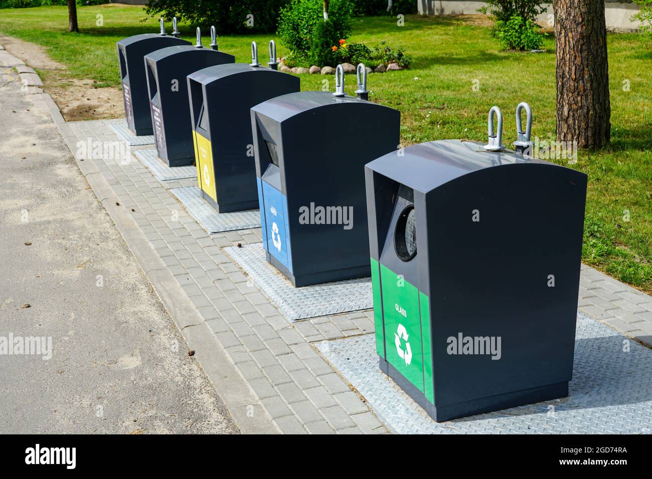 five different waste sorting containers on a city street Stock Photo ...