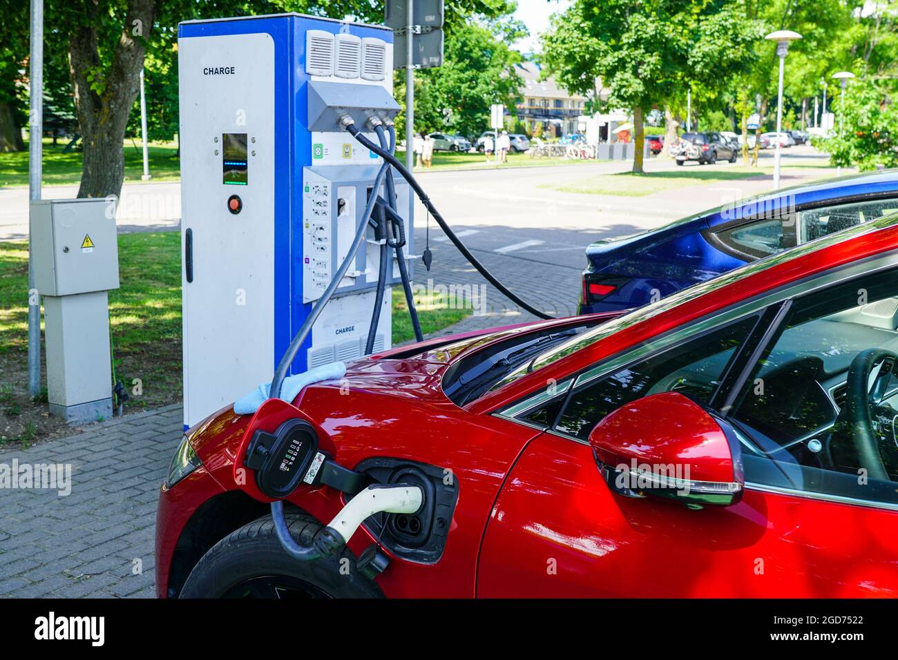 electric car charging station on a city street with a car connected to