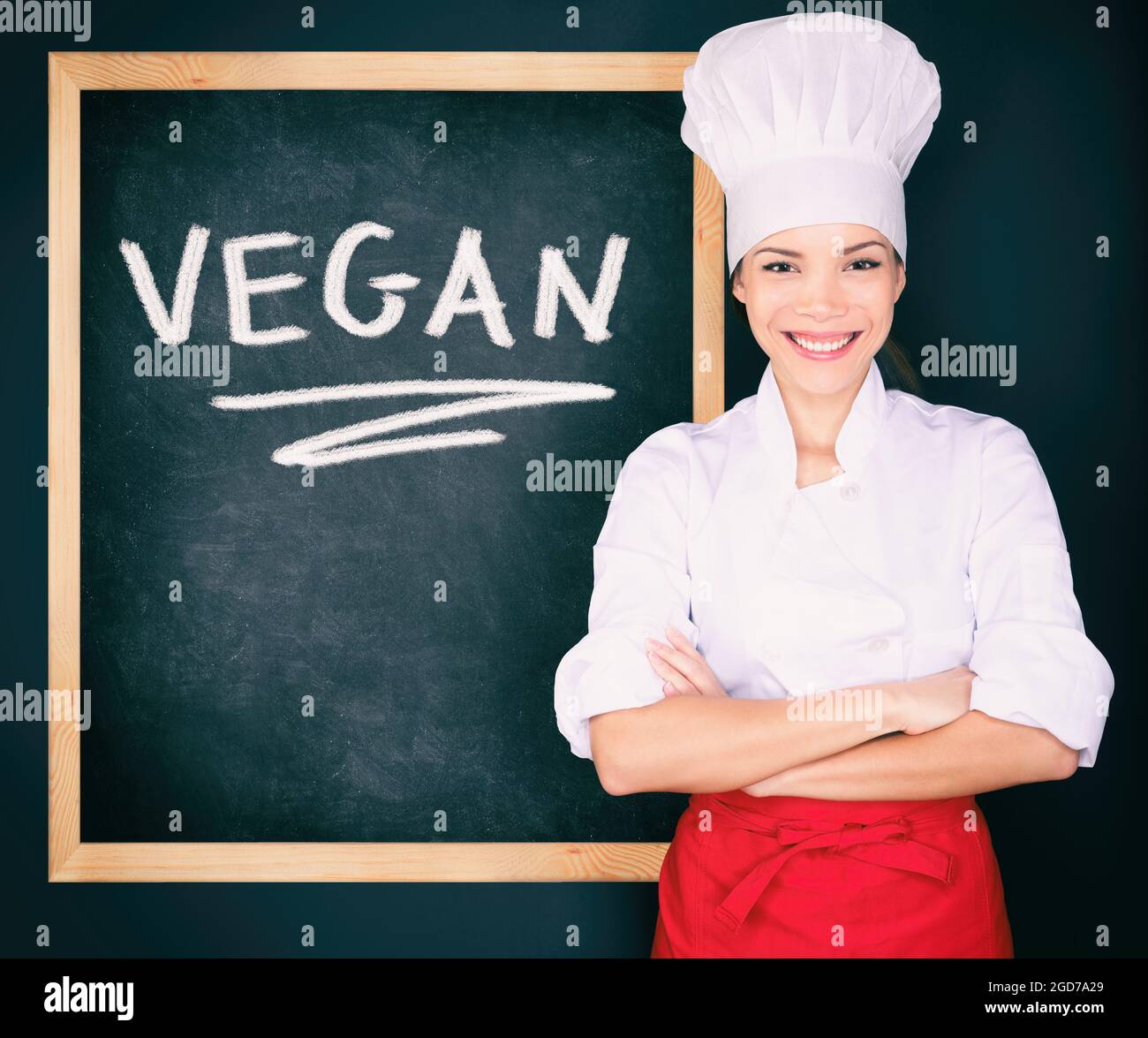 Vegan menu woman chef wearing uniform showing blackboard sign at restaurant  for today's special. Vegeterian food. Word VEGAN handwritten on black Stock  Photo - Alamy