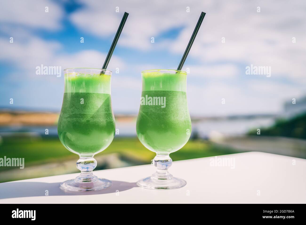 Green smoothies detox Healthy eating juice cleanse juices at cafe. Vegetarian diet juicing trend. Two glasses of spinach vegetable juice on outdoor Stock Photo