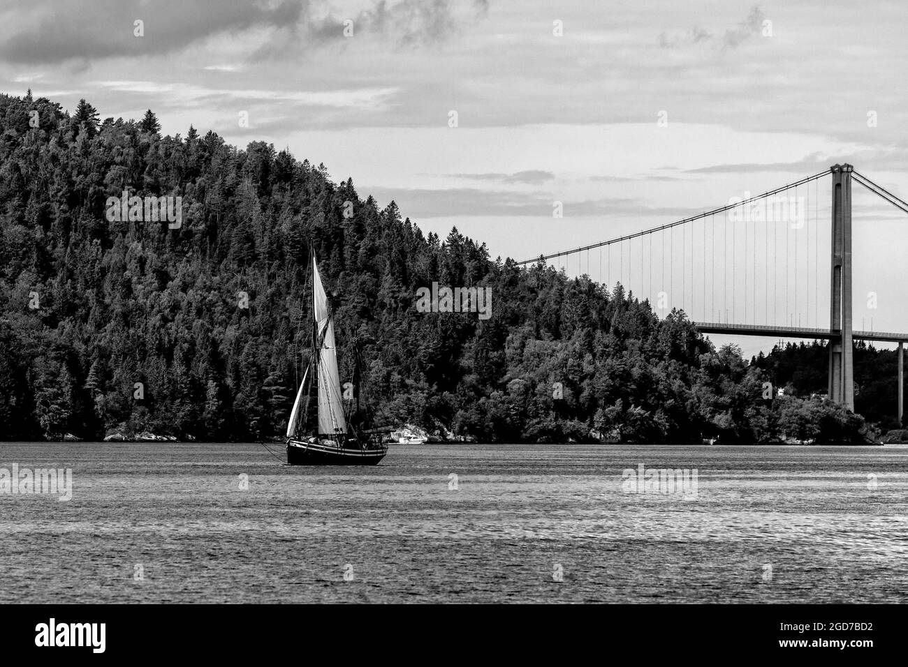 Veteran sailing vessel Seladon (built 1937) at Byfjorden, outside the port of Bergen, Norway. Askøybroen bridge in background Stock Photo