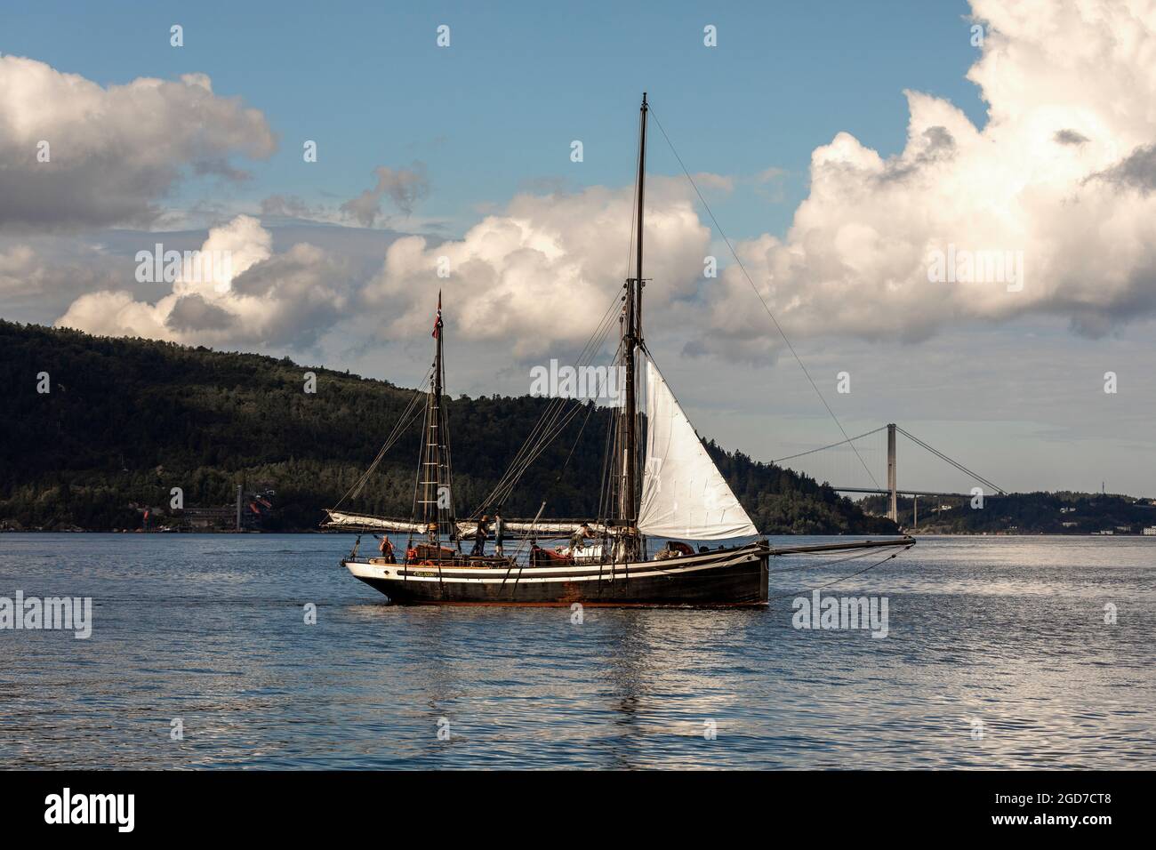Veteran sailing vessel Seladon (built 1937) at Byfjorden, outside the port of Bergen, Norway. Askøybroen bridge in background Stock Photo