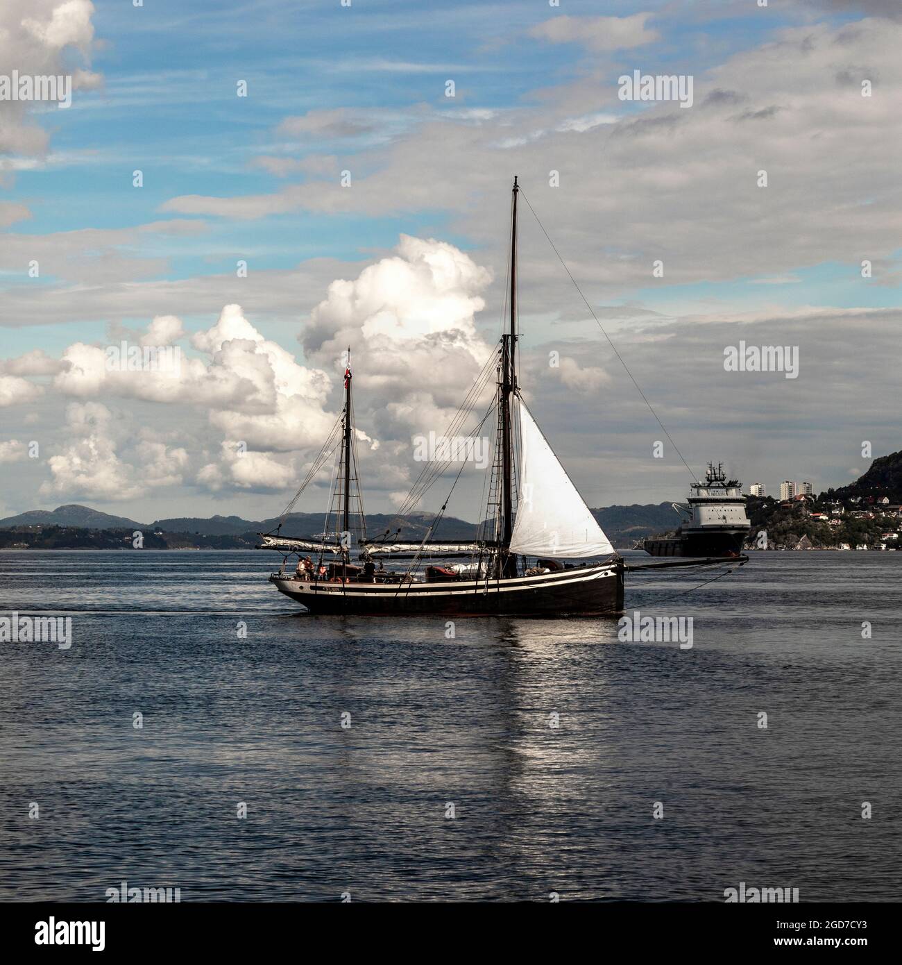 Veteran sailing vessel Seladon (built 1937) at Byfjorden, outside the port of Bergen, Norway.  Offshore supply vessel Island Chieftain in background Stock Photo