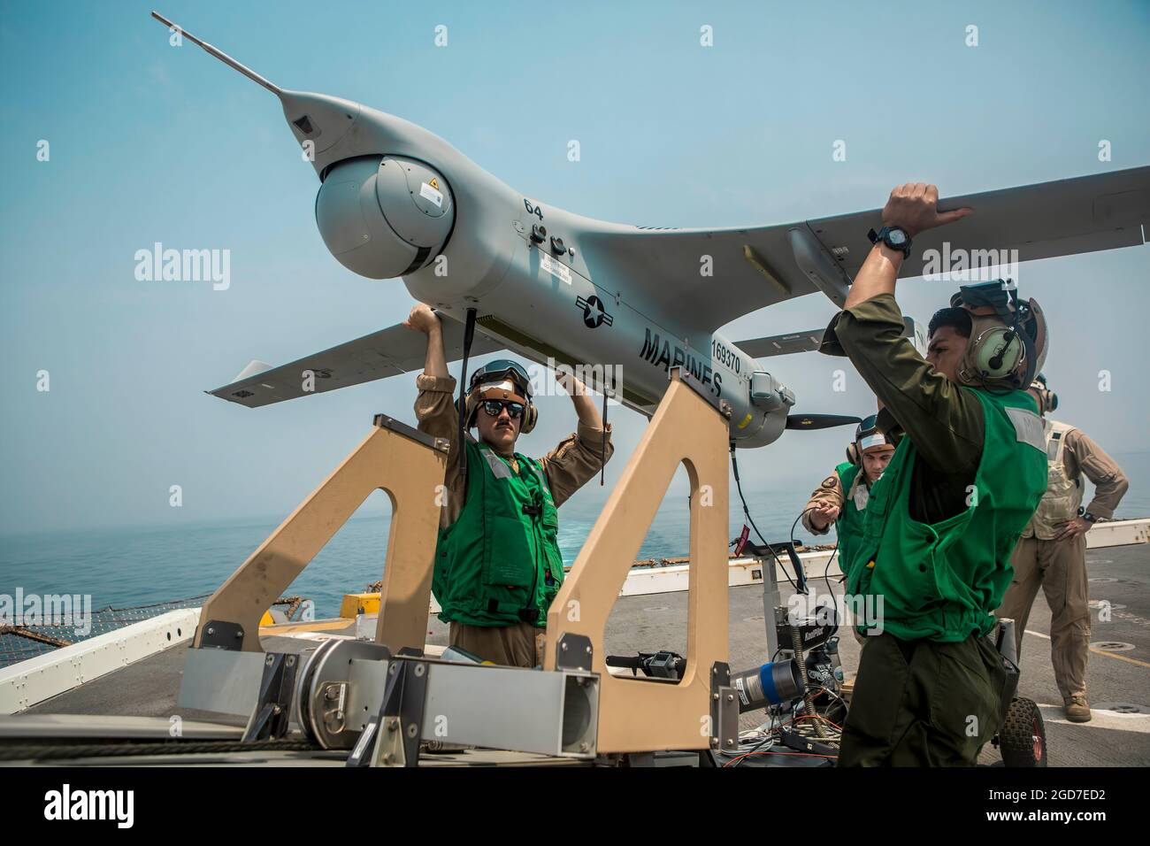190731-M-QP663-1019 ARABIAN GULF (July 31, 2019) Marines with Marine Medium Tiltrotor Squadron (VMM) 163 (Reinforced), 11th Marine Expeditionary Unit (MEU) lift an RQ-21A Blackjack unmanned aerial system (UAS) onto a launcher before flight operations aboard the amphibious transport dock ship USS John P. Murtha (LPD 26). The Boxer Amphibious Ready Group and the 11th MEU are deployed to the U.S. 5th Fleet area of operations in support of naval operations to ensure maritime stability and security in the Central Region, connecting the Mediterranean and the Pacific through the western Indian Ocean Stock Photo