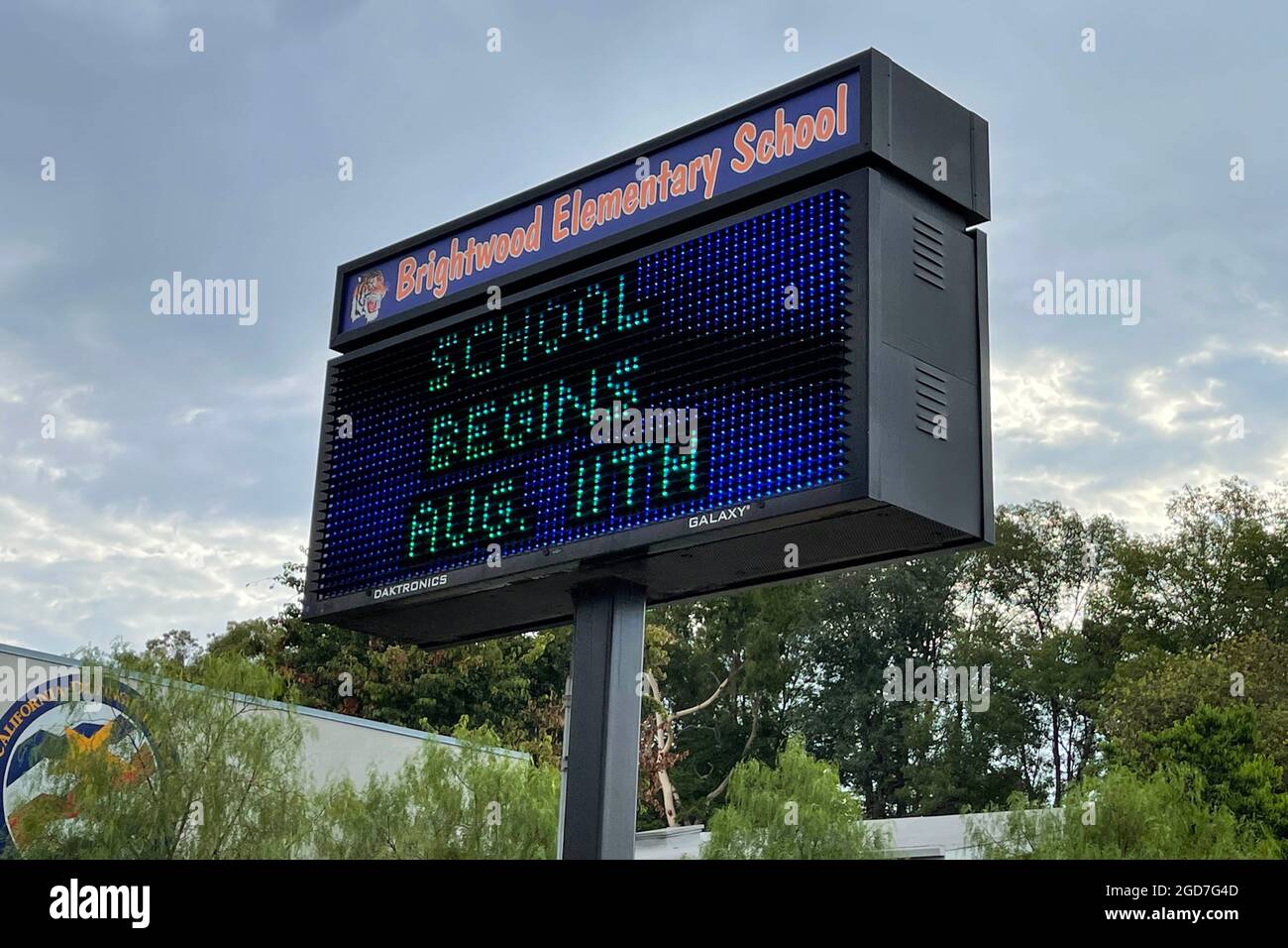 A School Begins Aug. 11 sign at Brightwood Elementary School, Wednesday, Aug. 11, 2021, in Monterey Park, Calif. Stock Photo