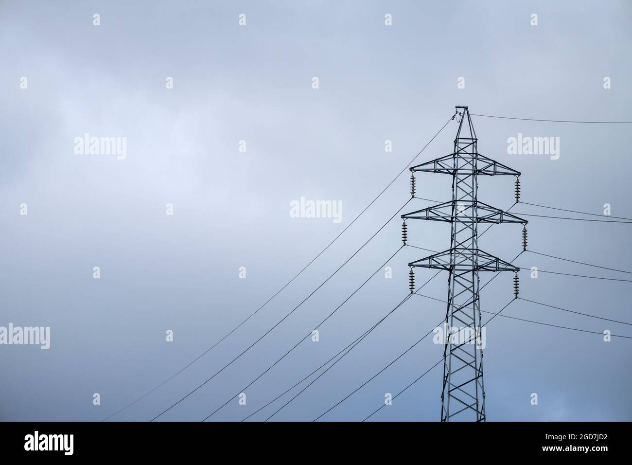 Electrical power pylon on cloudy blue sky Stock Photo