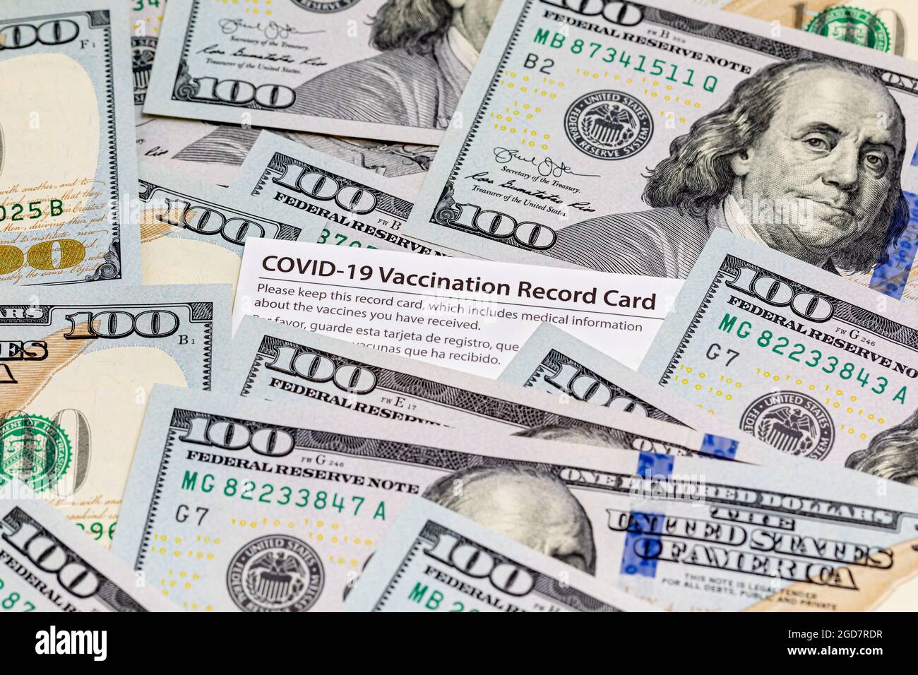 Covid-19 vaccination card and cash money. Covid vaccine lottery, bonus and incentive concept Stock Photo