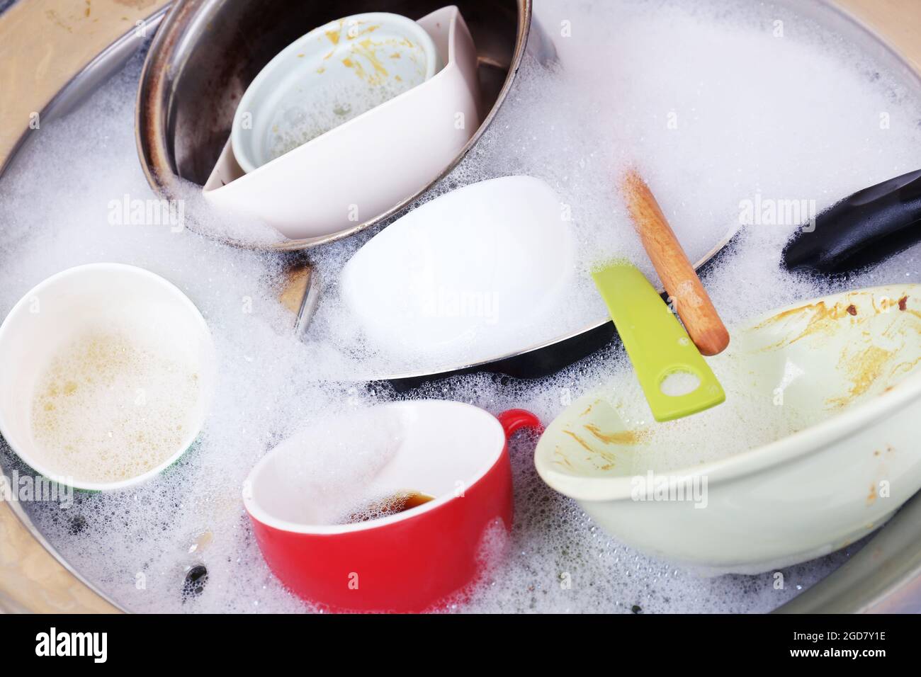 Utensils soaking in kitchen sink Stock Photo Alamy