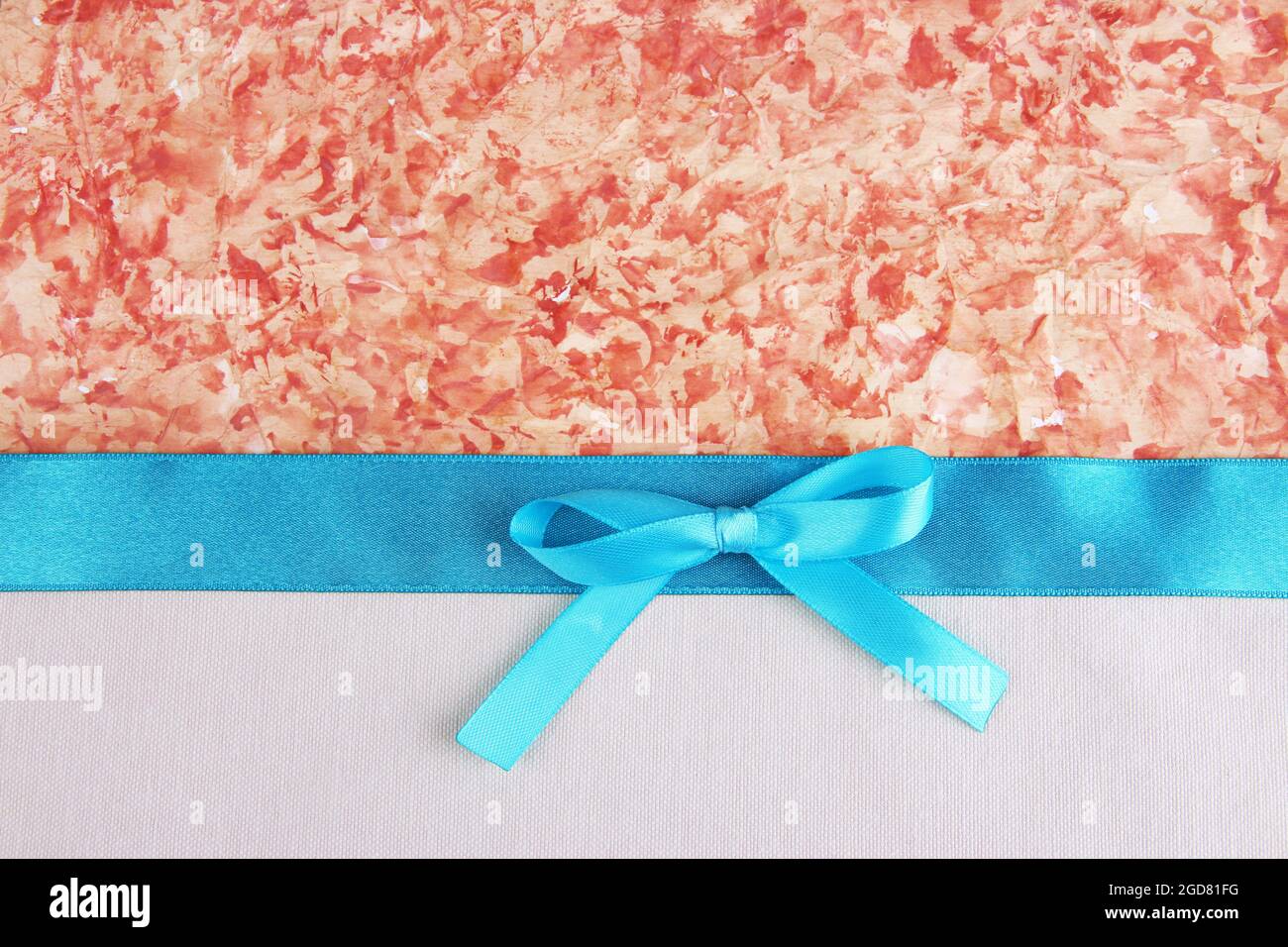 Beige fabric with color ribbon and bow on color paper background Stock