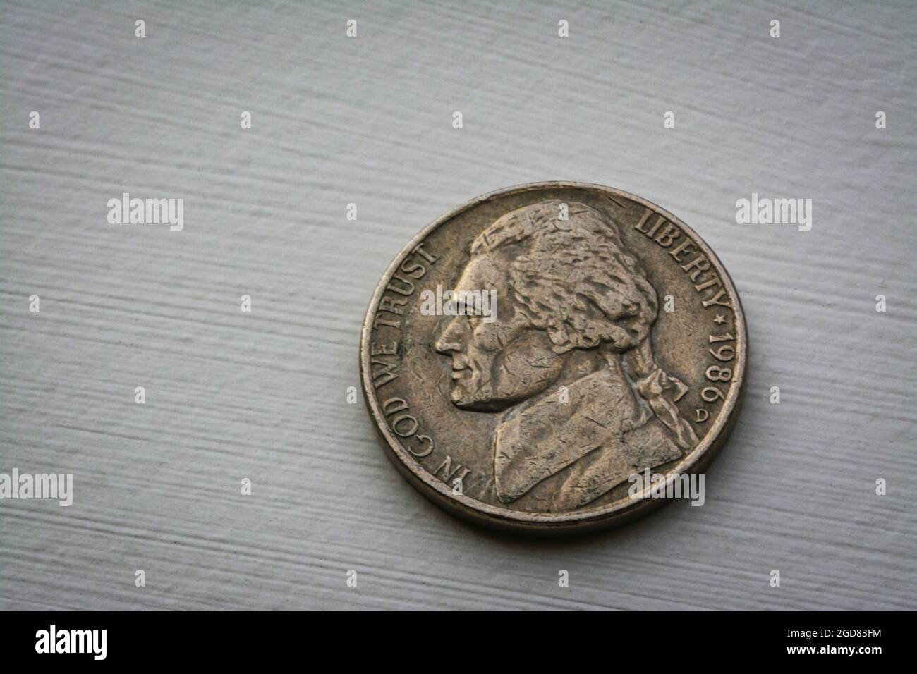 Macro image of scarred and dirty Thomas Jefferson US nickel coin, minted in Denver Colorado 1986, Castle Rock Colorado USA. Stock Photo