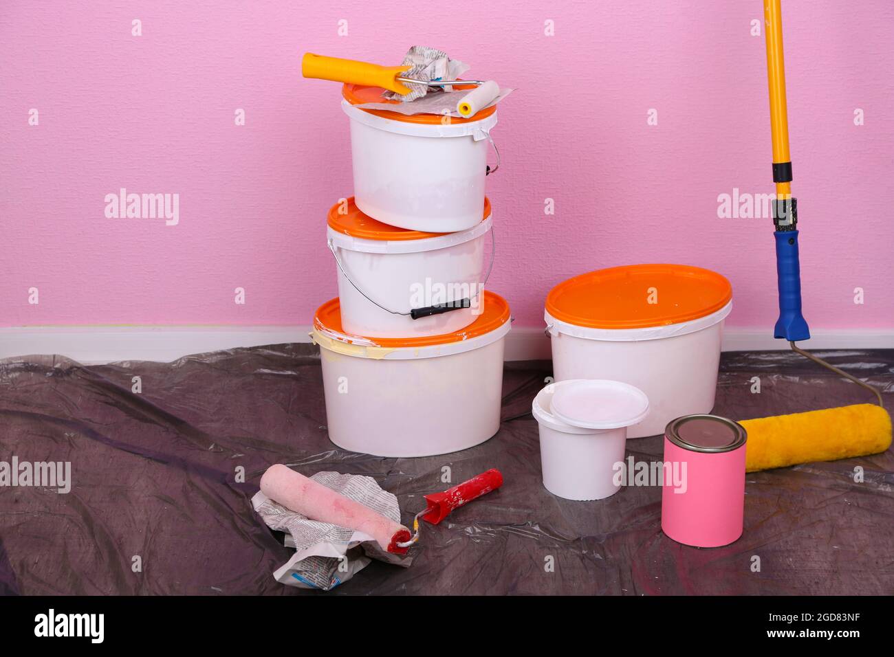 Buckets with paint and ladder on wall background. Conceptual photo of