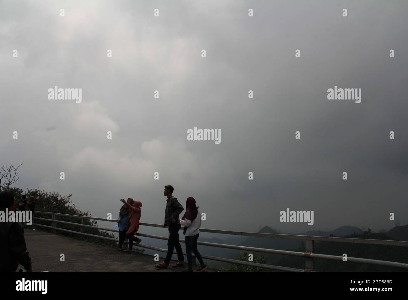 KEDIRI, INDONESIA - March 25, 2016: Tourists enjoying the scenery at the Mount Kelud tourist site Stock Photo