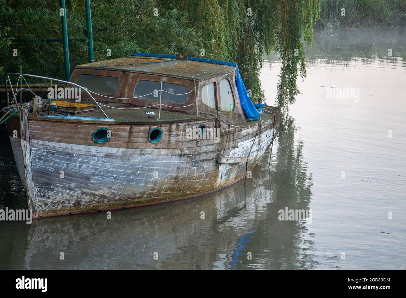 Boat in a misty morning on a still river, calm water Stock Photo - Alamy