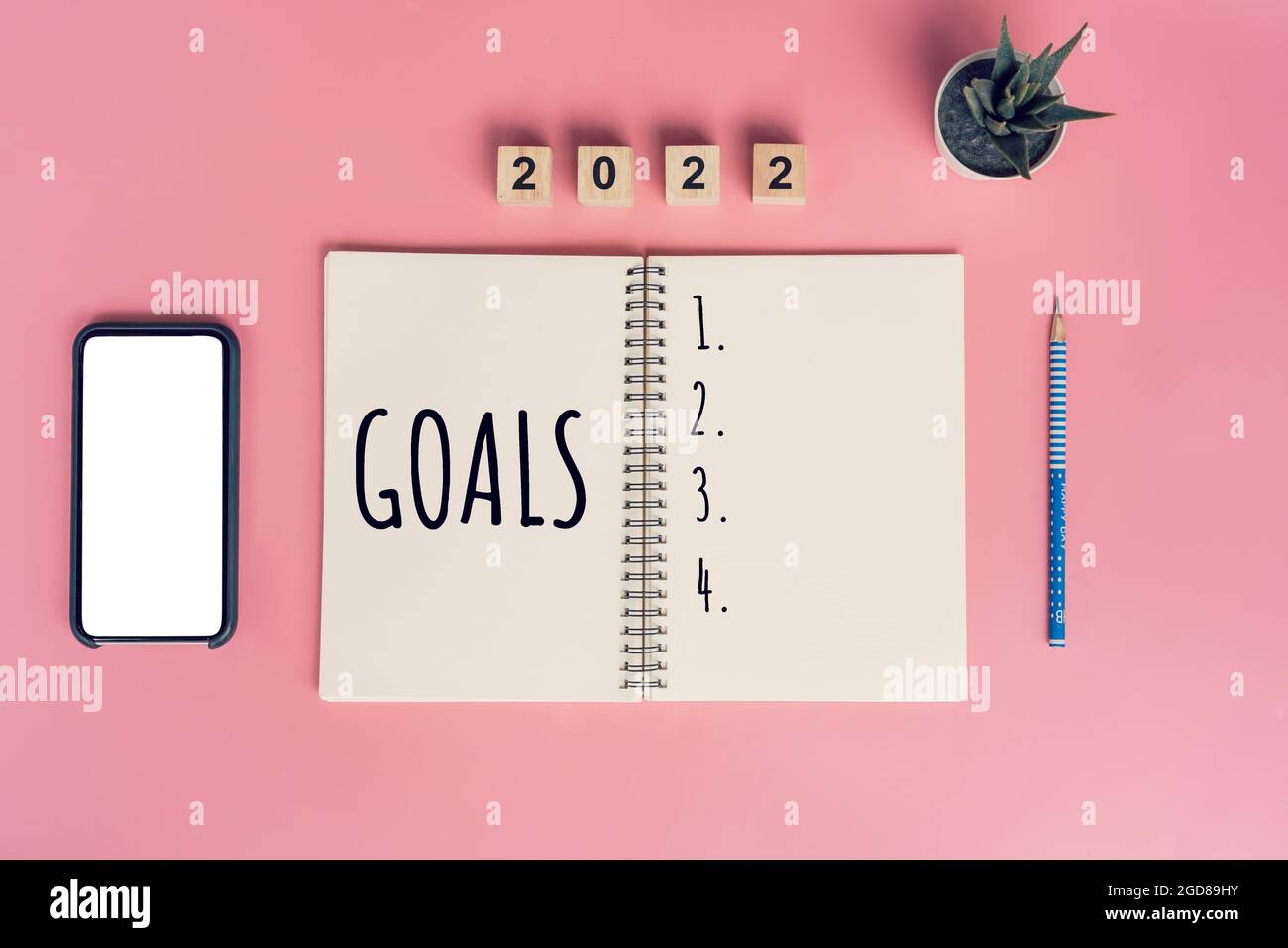Notebooks with empty goals for 2022 year and phone on color background Stock Photo