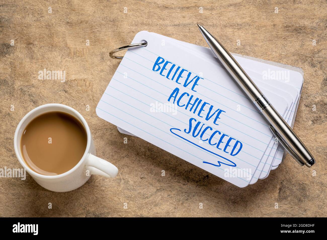 believe, achieve, succeed motivational words - handwriting on a stuck of index card with a cup of coffee, business, goal setting and personal developm Stock Photo