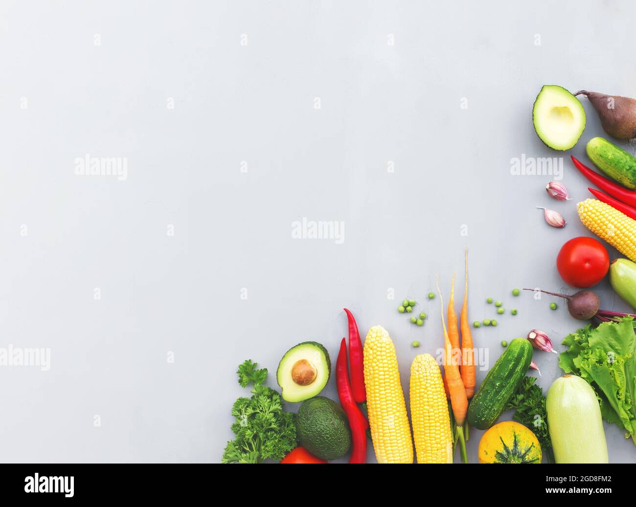 Flat lay with different vegetables, fruits, berries, nuts, spices, herbs, olive oil. Copy space area for some text. Veggies on grey concrete backgroun Stock Photo