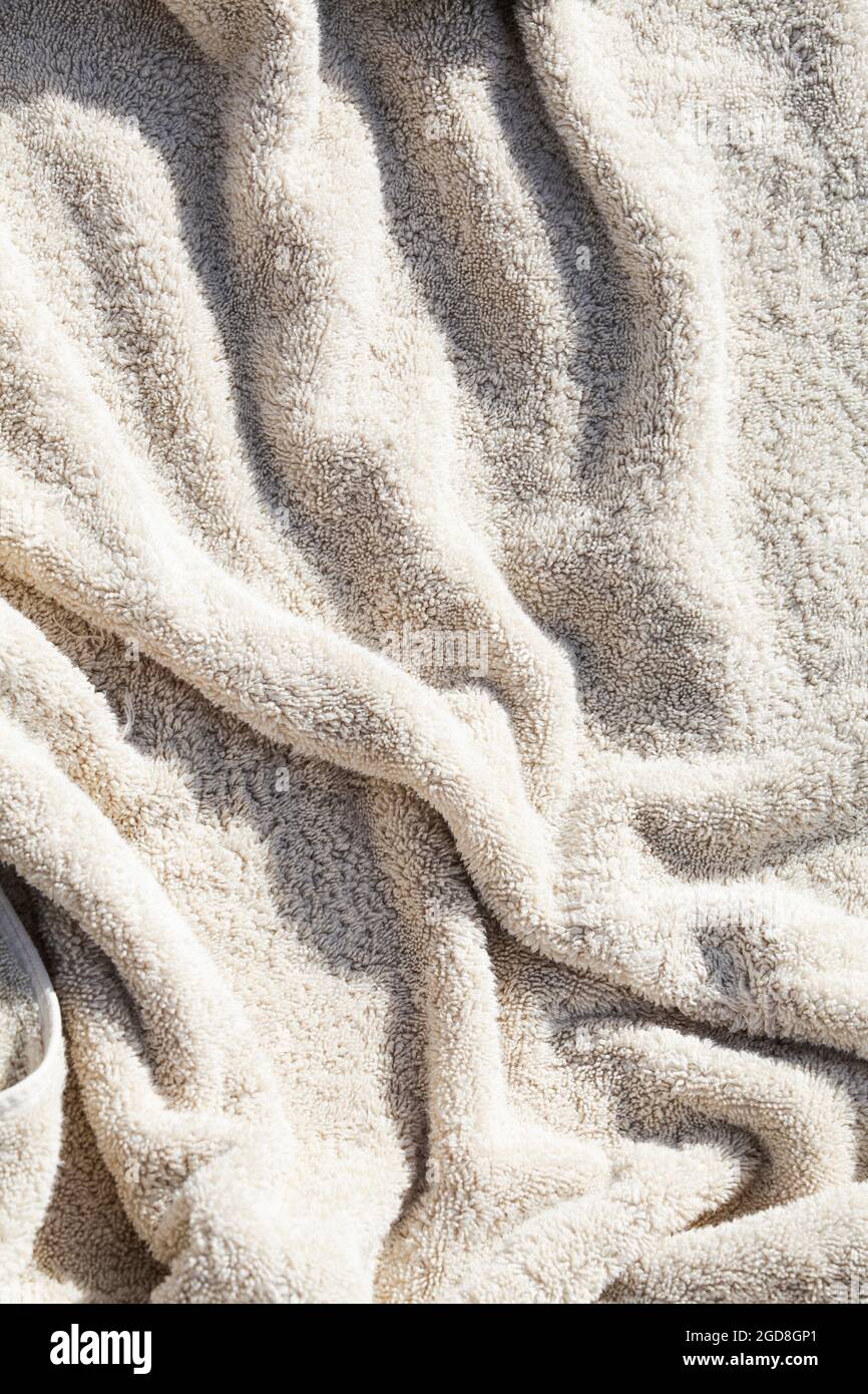grey towel texture with deep shadow. soft cotton towel backdrop, fabric background. Terry cloth bath or beach towels. Soft fluffy Textile Stock Photo