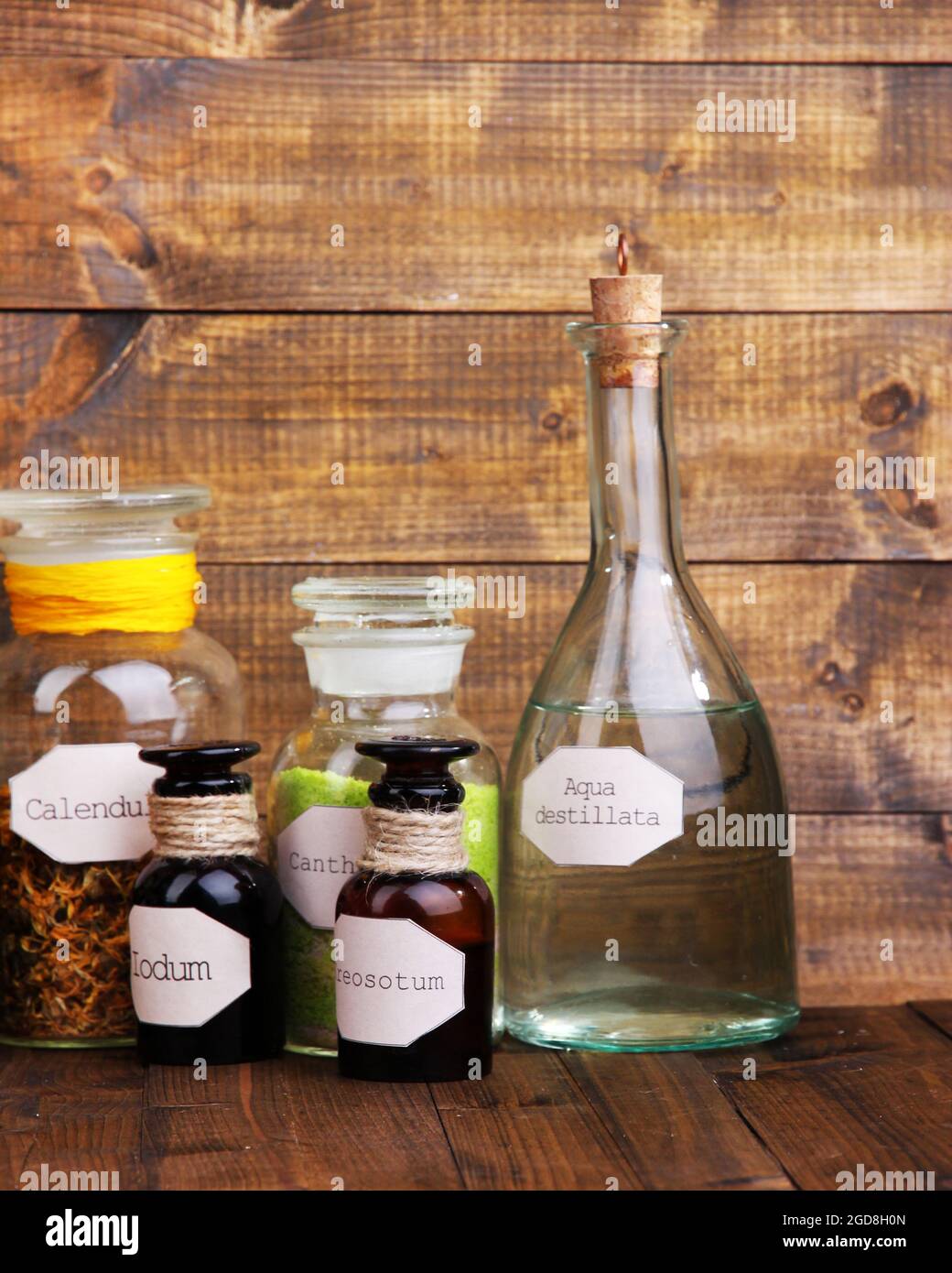 Historic old pharmacy bottles with label on wooden background Stock