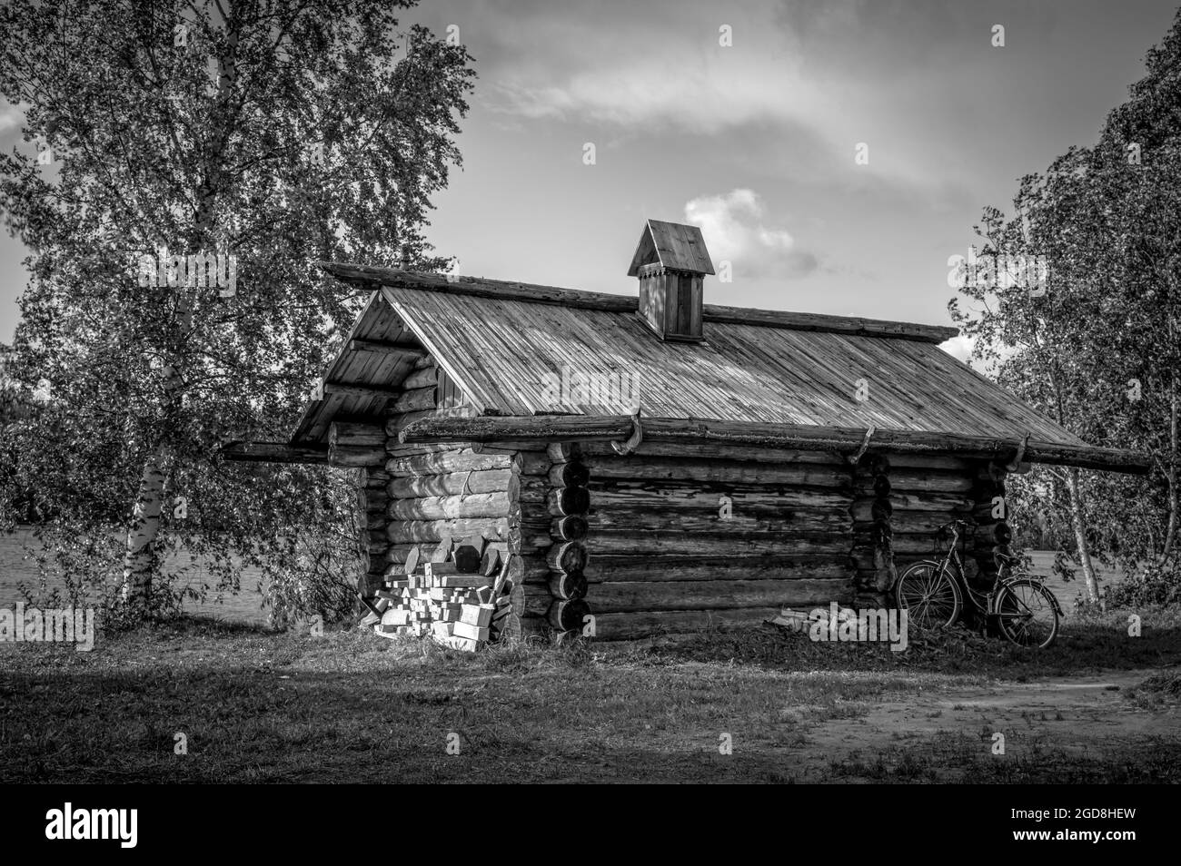Ancient wooden house on the bank of the Svir river. Mandrogi Village, Russia. Black and white. Stock Photo