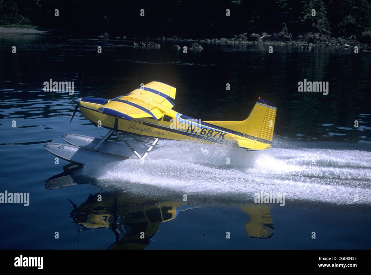 Cessna 180 floatplane landing in Frederick Sound in SE Alaska Stock Photo